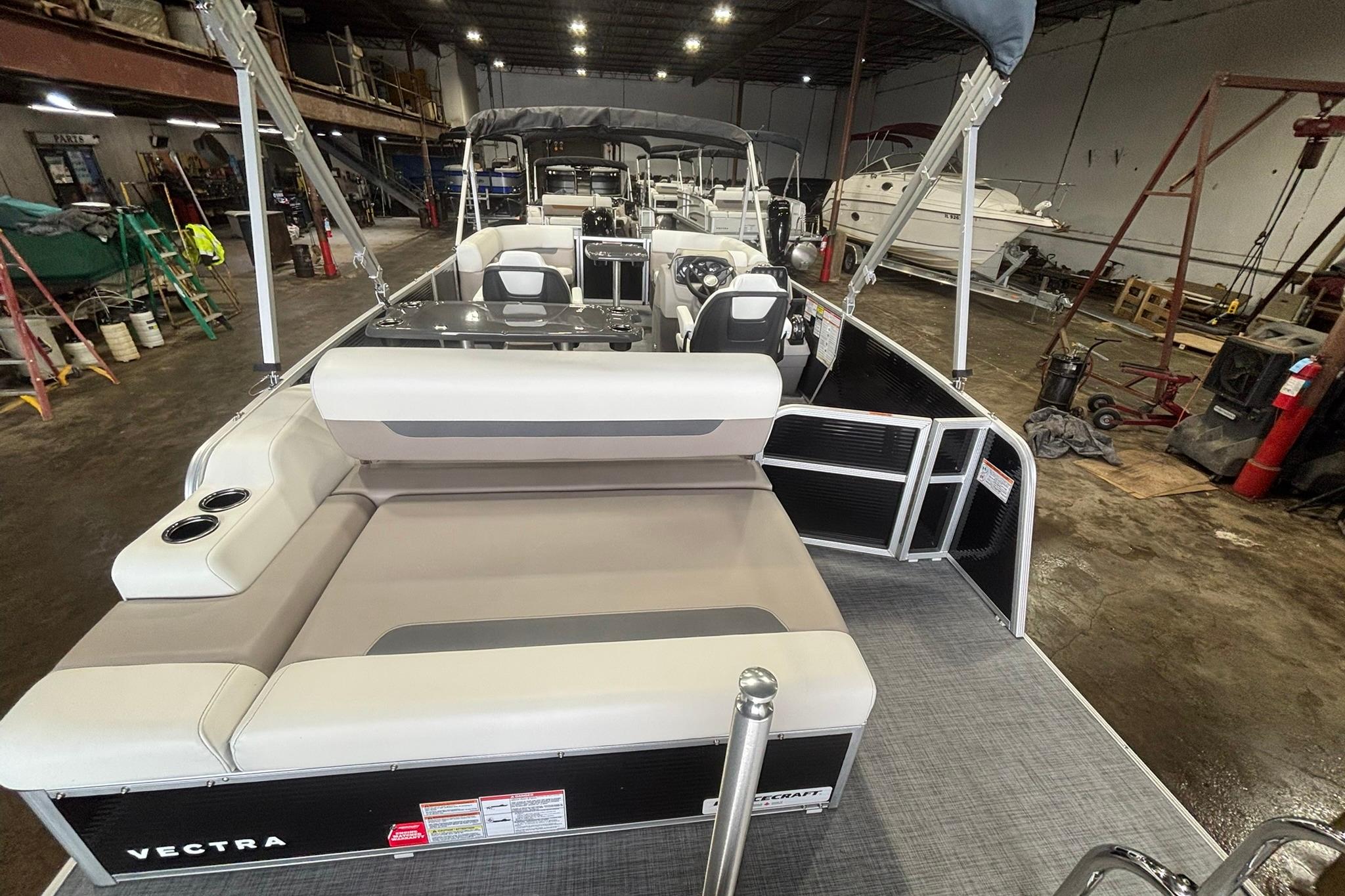 2025 Princecraft Vectra 21 RL pontoon boat in a warehouse setting.