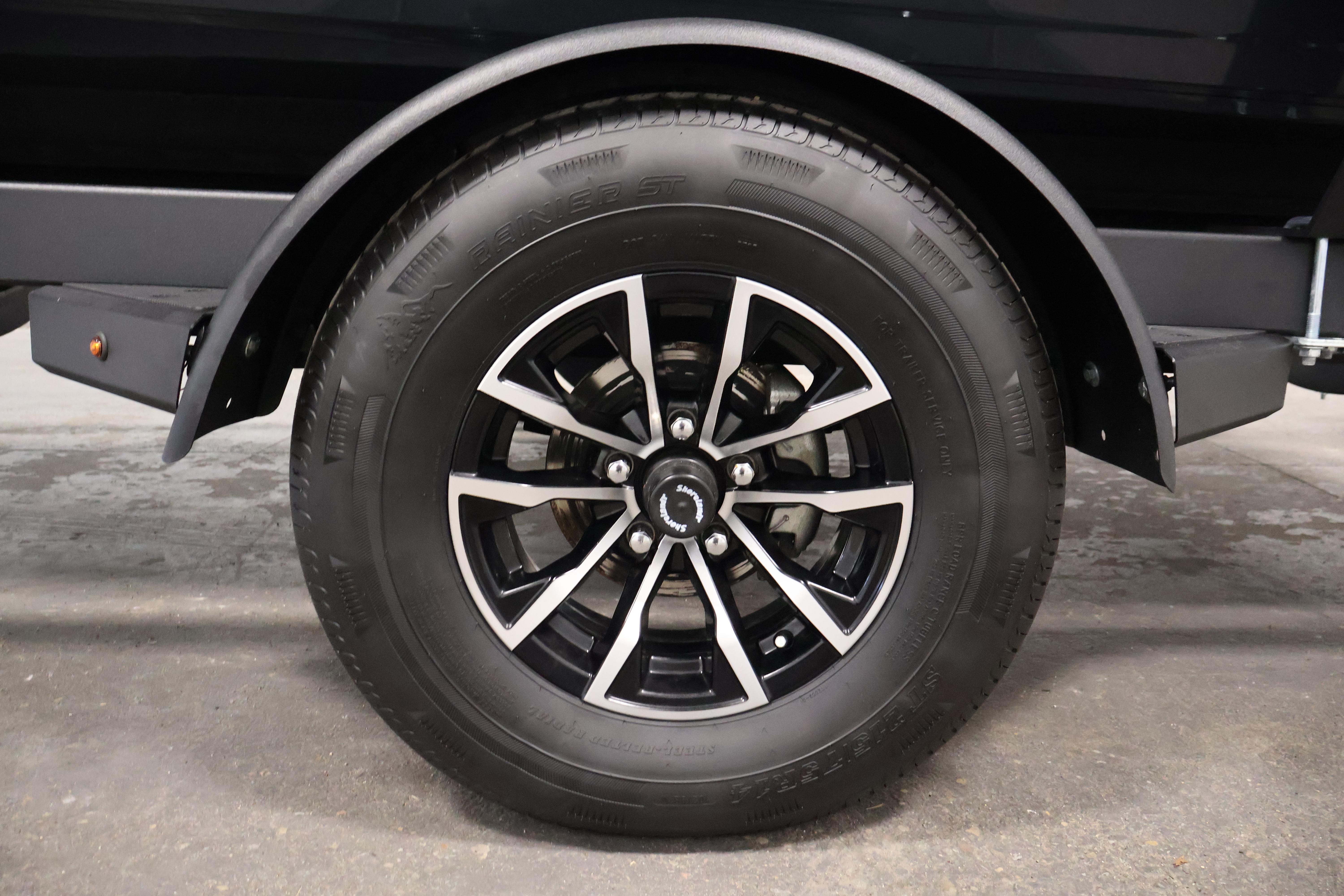 2026 Crestliner 1850 Kodiak SC trailer wheel with black alloy rim.