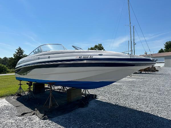 2004 Starcraft Aurora 2410 boat on stands, displayed outdoors on gravel.