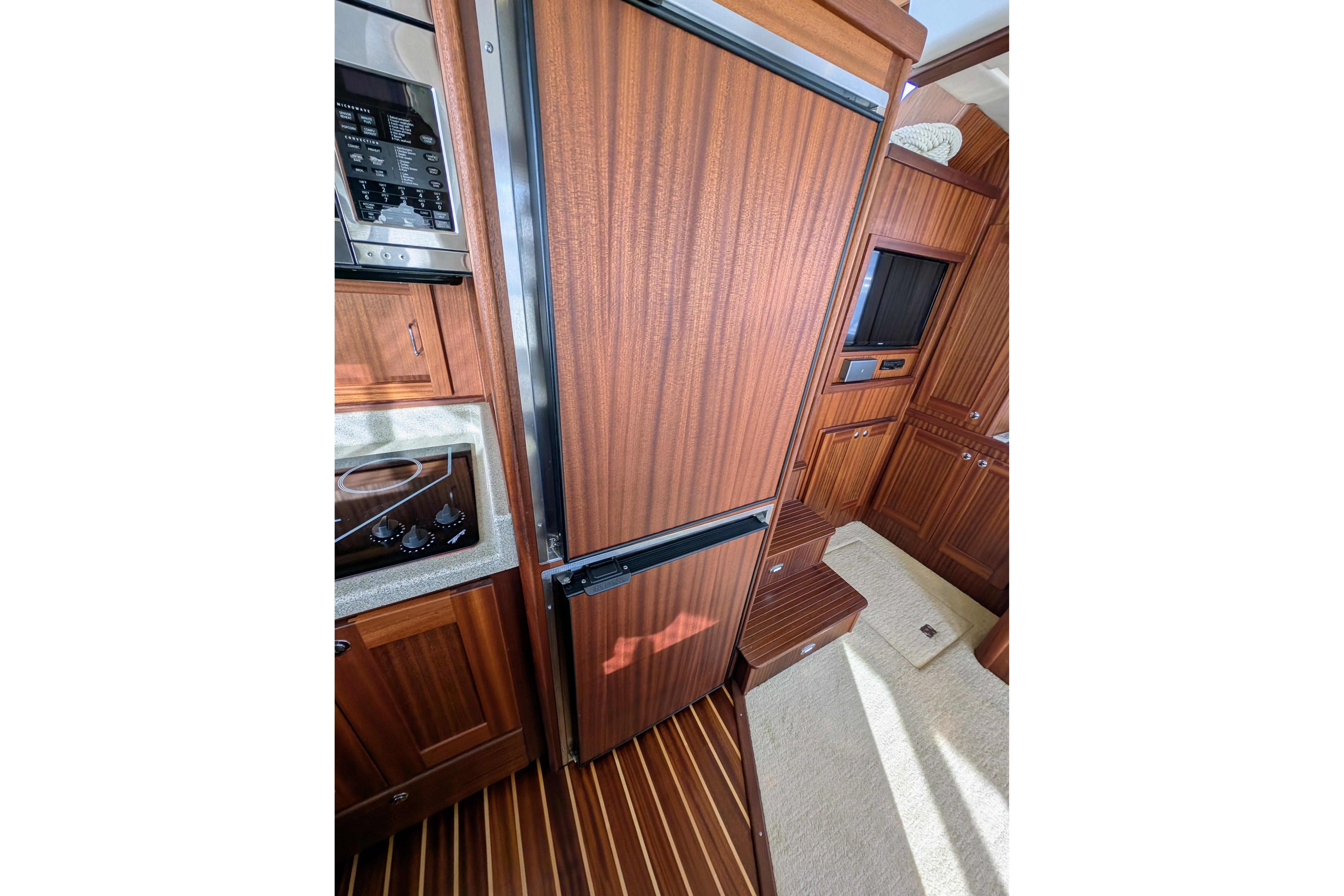 Interior of 2015 American Tug 435, featuring wood cabinetry and modern appliances.