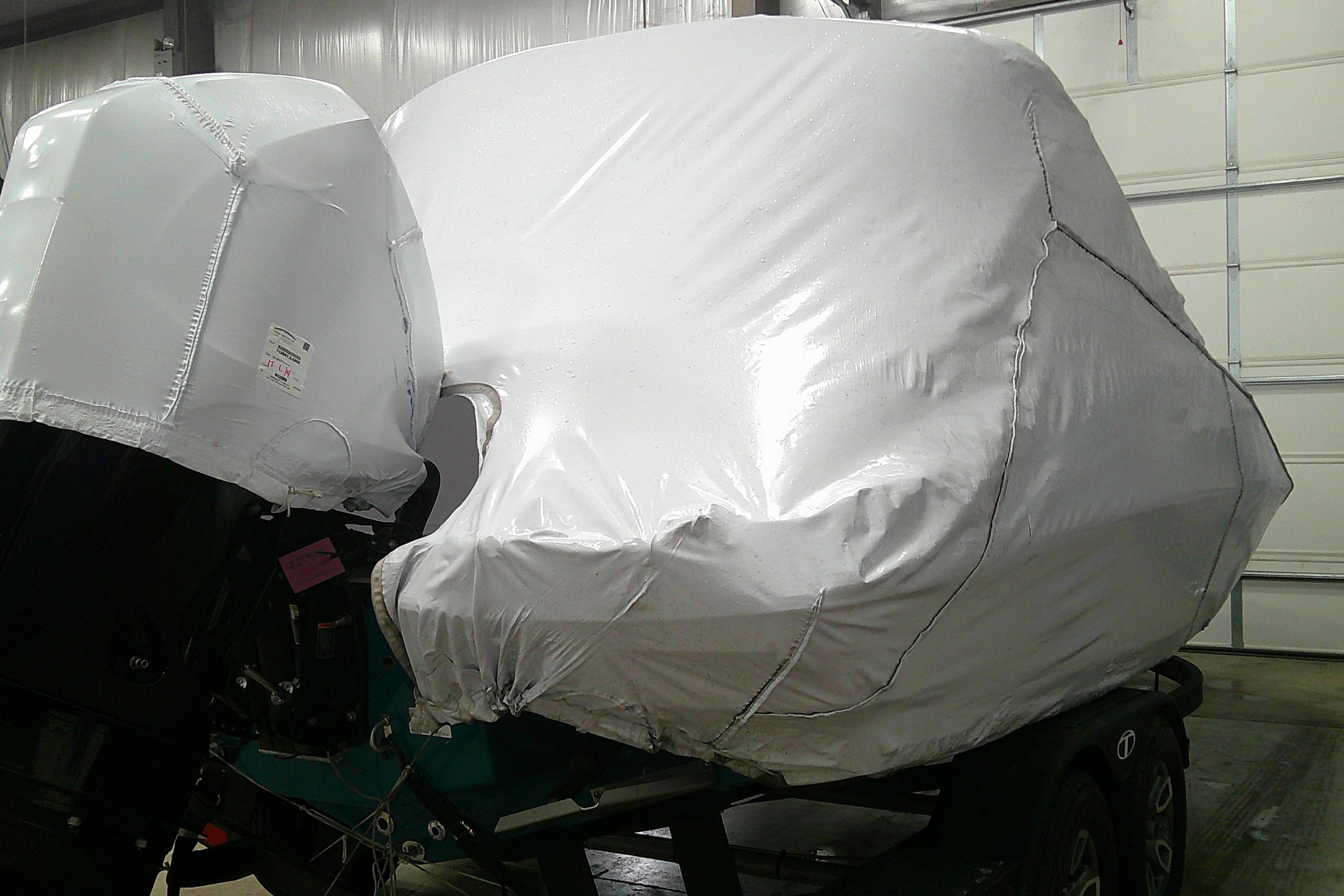 Covered 2026 Tahoe 2150 CC boat on trailer in storage facility.