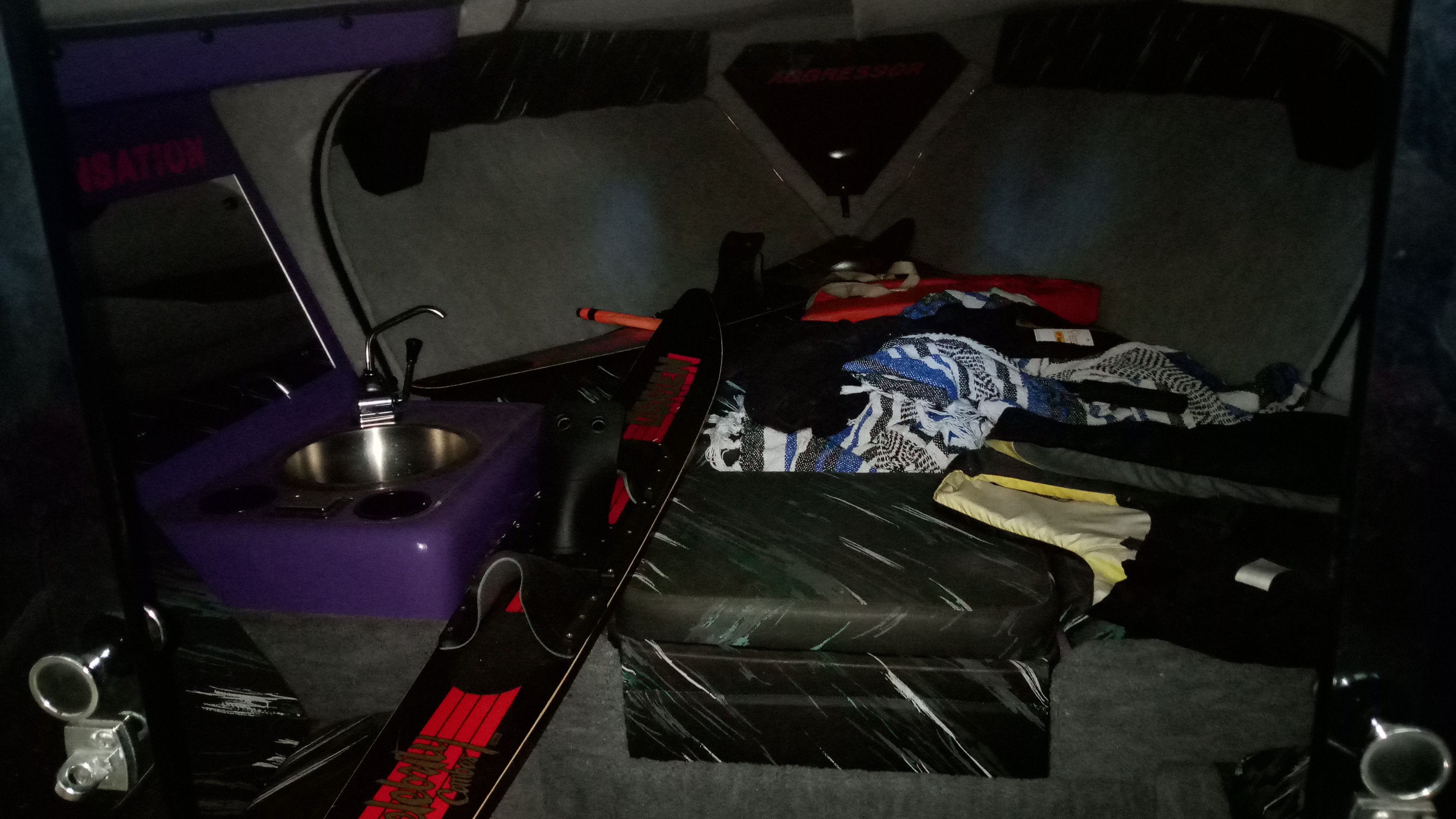 Interior of a 1993 Sunsation Aggressor boat with sink and gear.