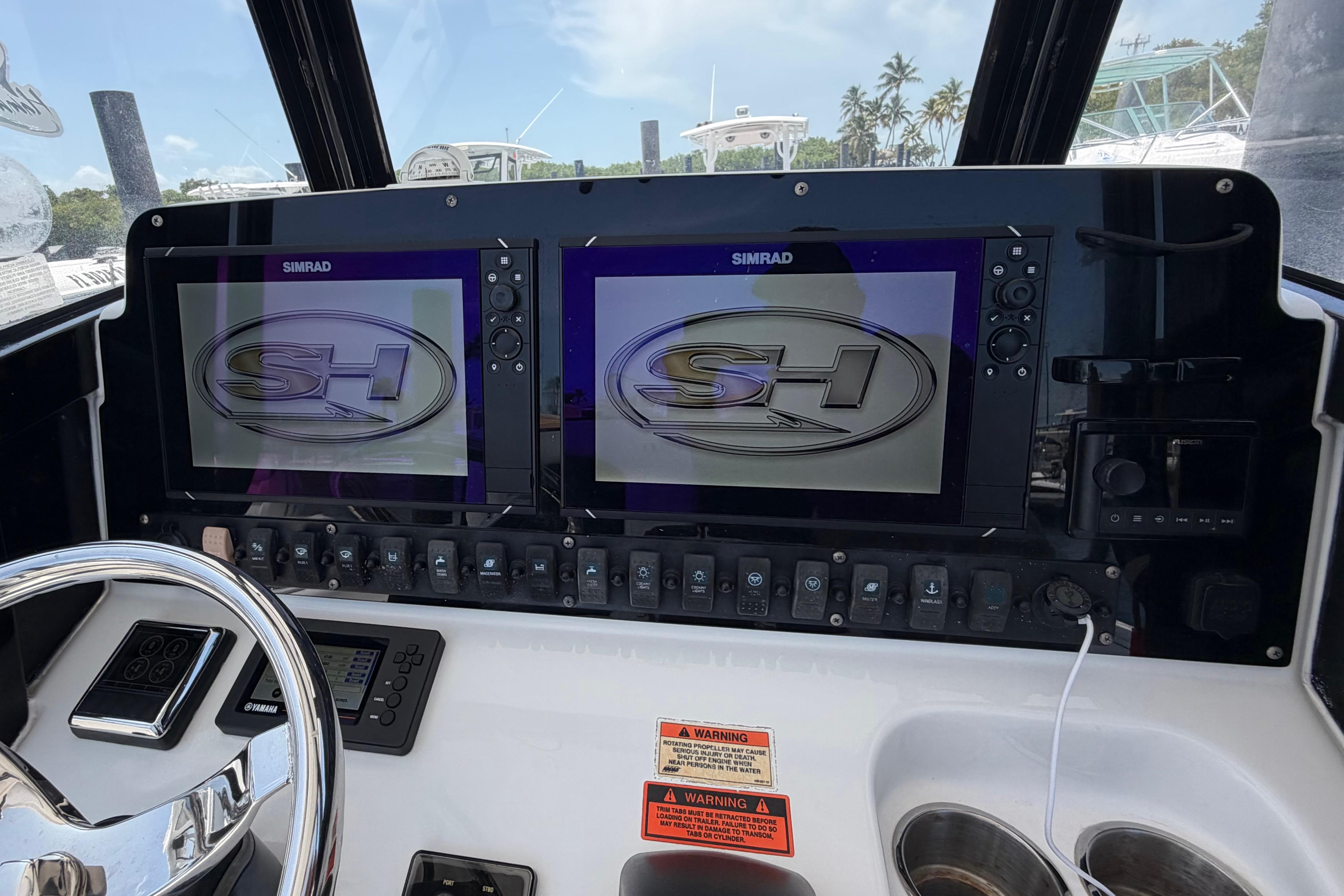 2019 Sea Hunt Gamefish 27 dashboard with dual Simrad displays and control panel.