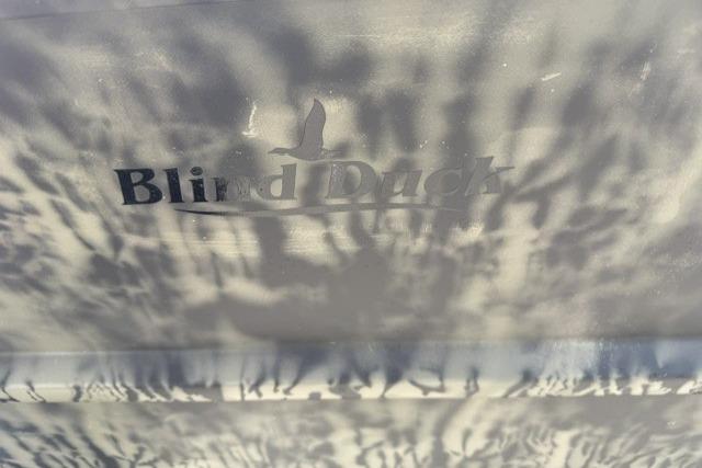 Shadowy "Blind Duck" logo on 2026 Tracker Grizzly 1754 Utility surface.
