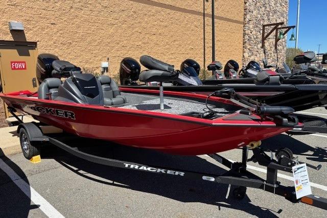 2026 Tracker Pro Team 175 boat in red, parked on a trailer outdoors.