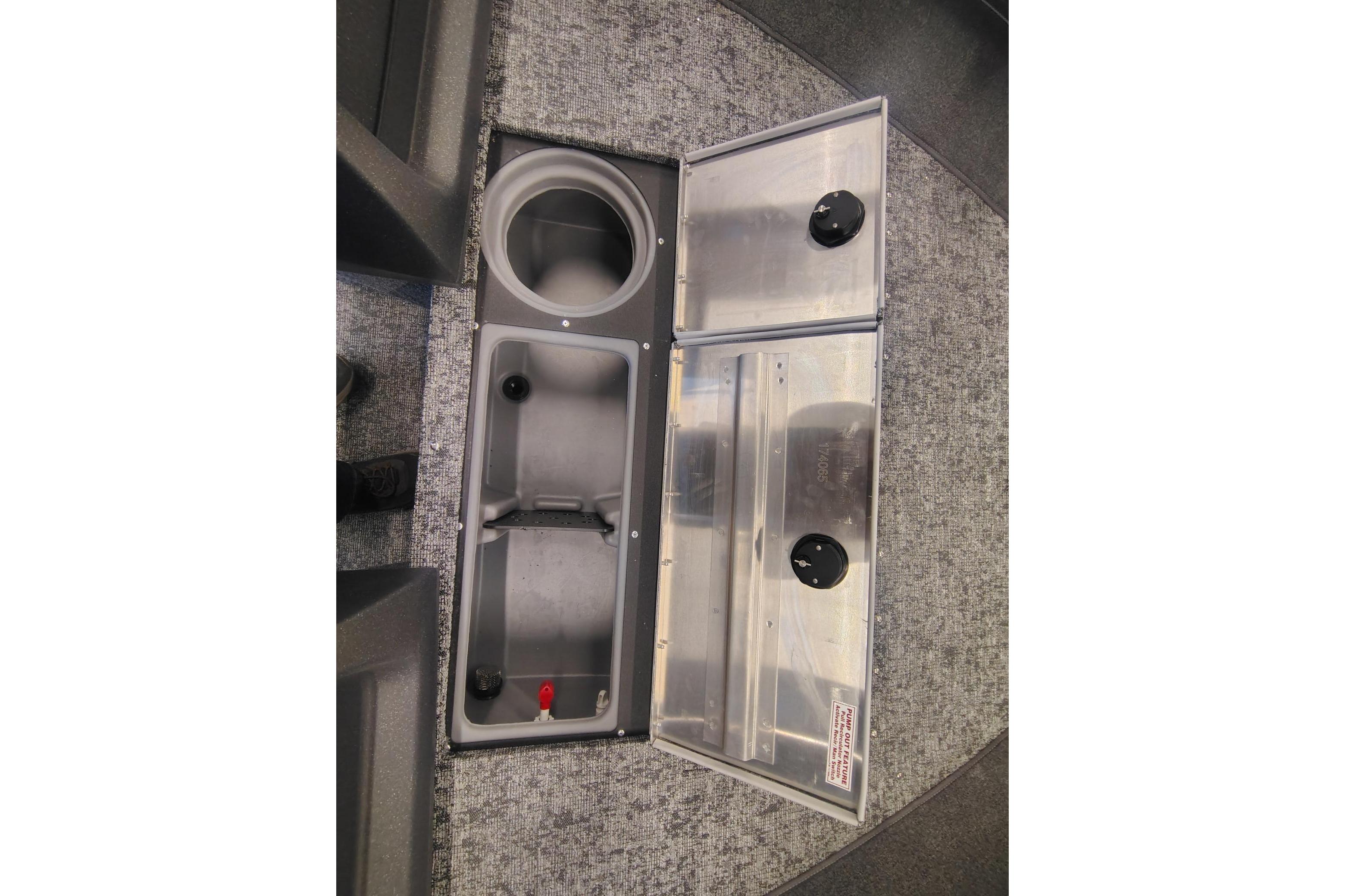 Storage compartments in a 2026 Tracker Pro Guide V-16 WT boat, featuring cup holder and utility space.