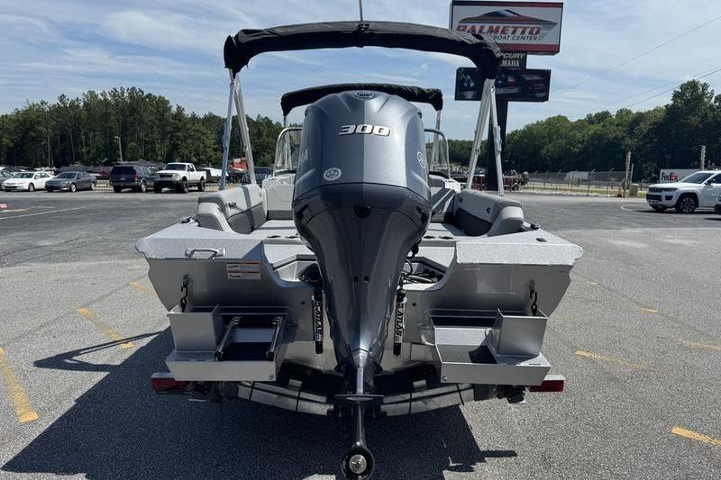2025 SeaArk Super Lounge Easy boat with powerful 300 HP engine, parked outdoors.