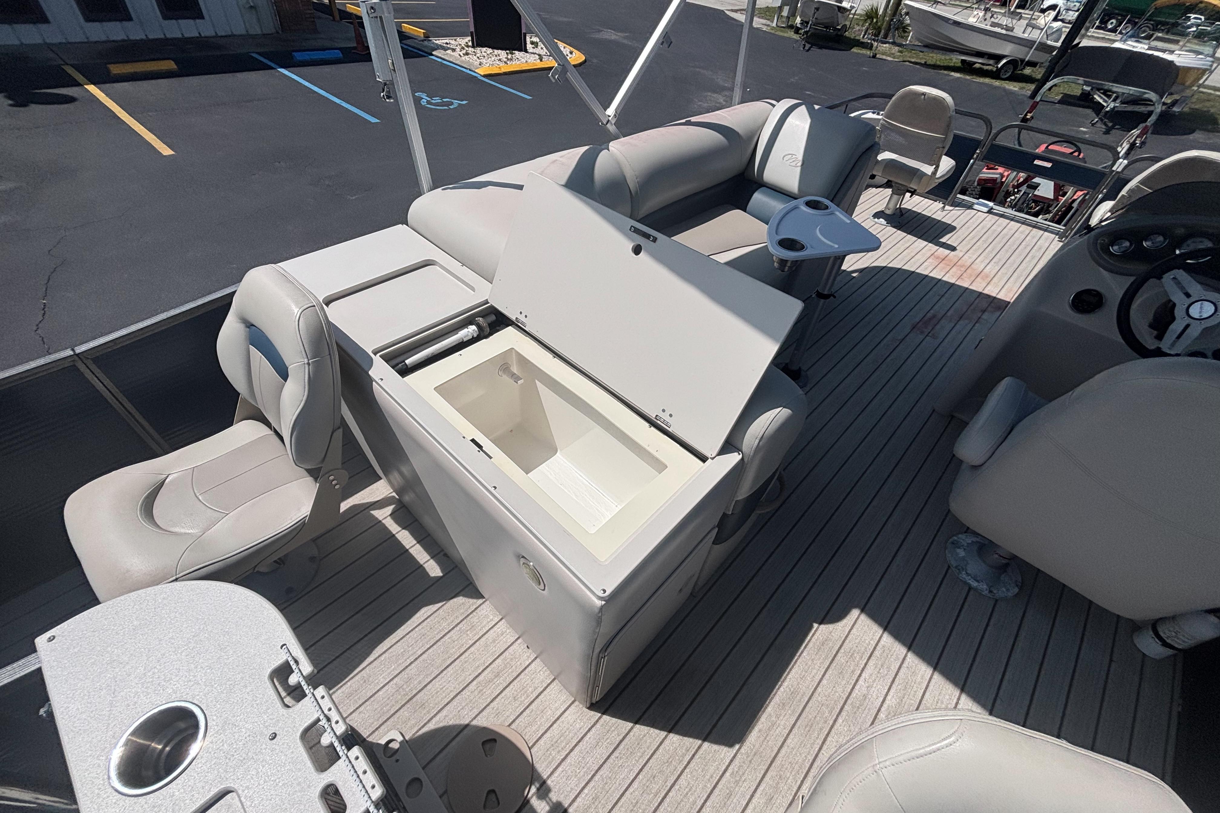 2015 Manitou 20 Oasis Angler boat interior with open storage compartment.