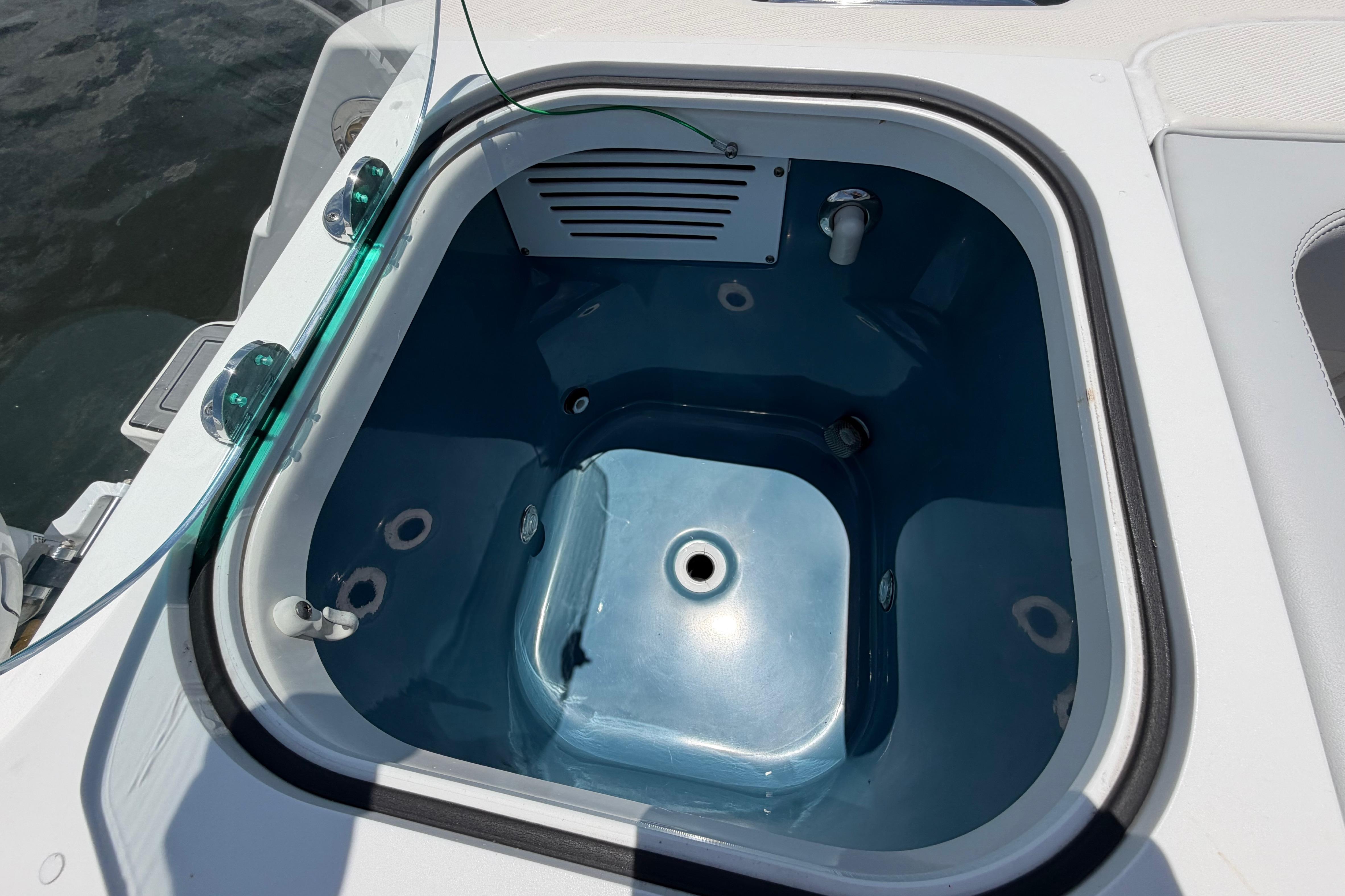 Livewell on 2009 Everglades 350LX boat, featuring a blue interior and water inlet.