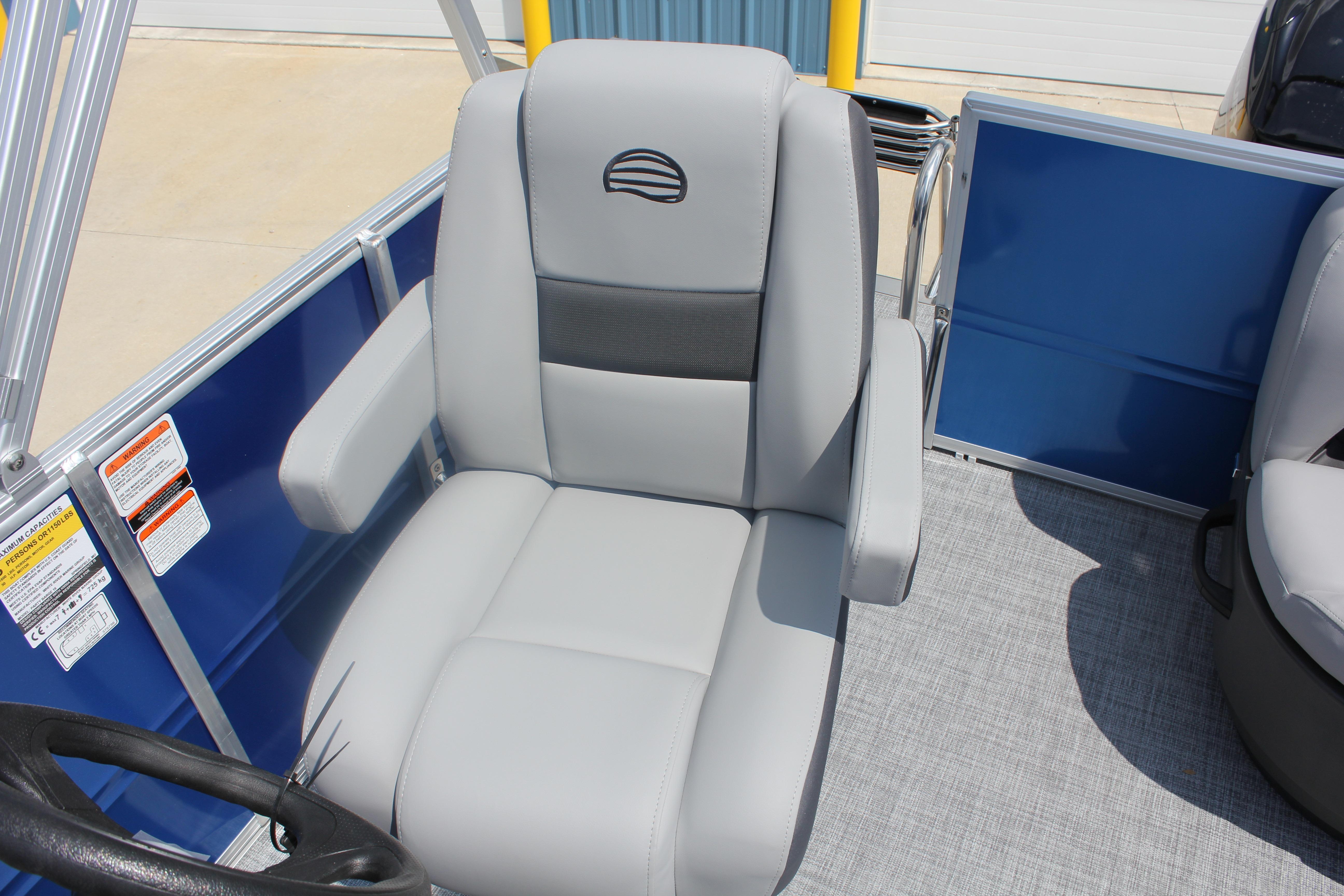 2026 Sun Tracker Party Barge 16 DLX captain's chair with gray upholstery and armrests.