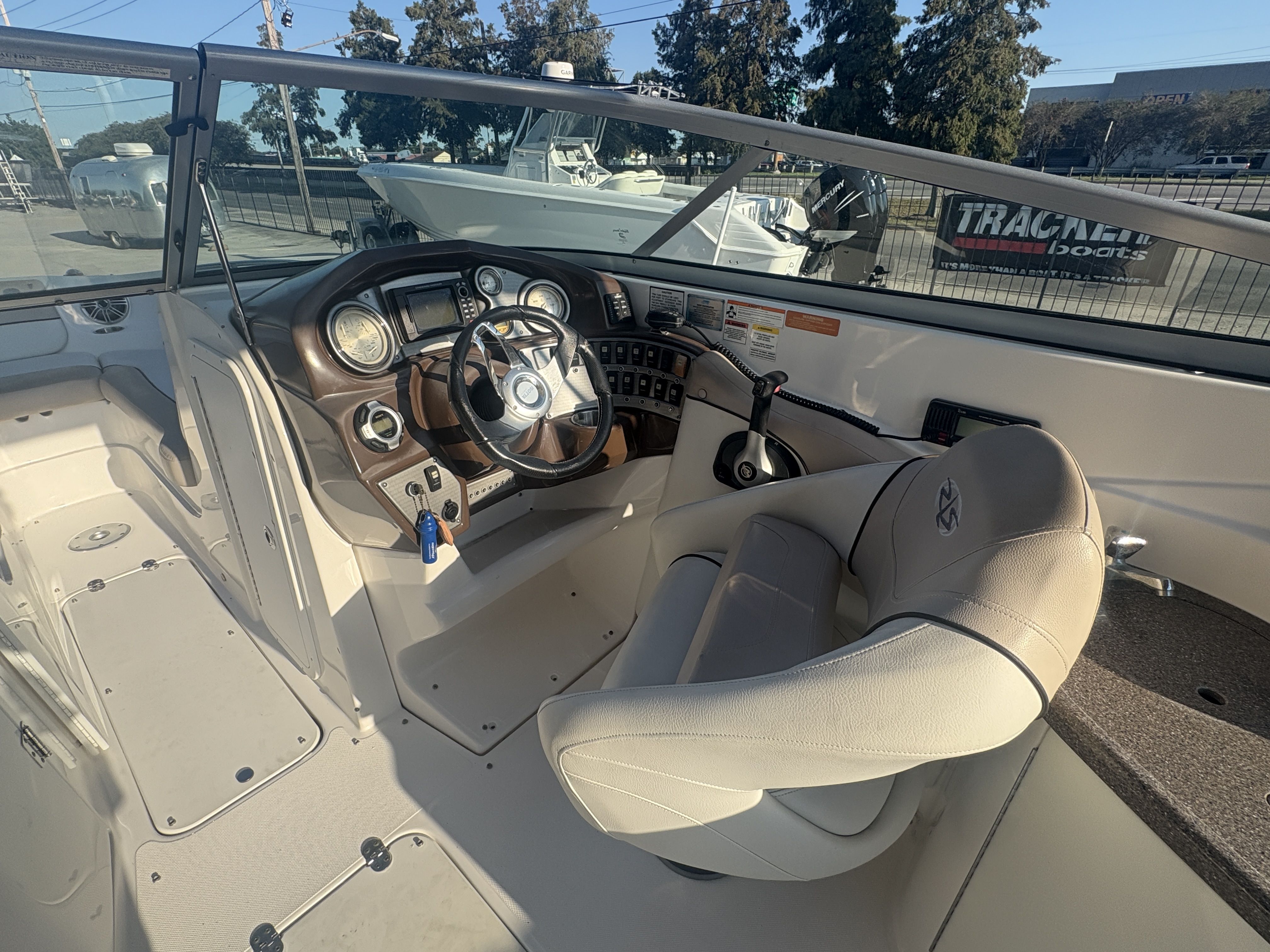 2013 Rinker Captiva 276 boat cockpit with steering wheel and control panel.