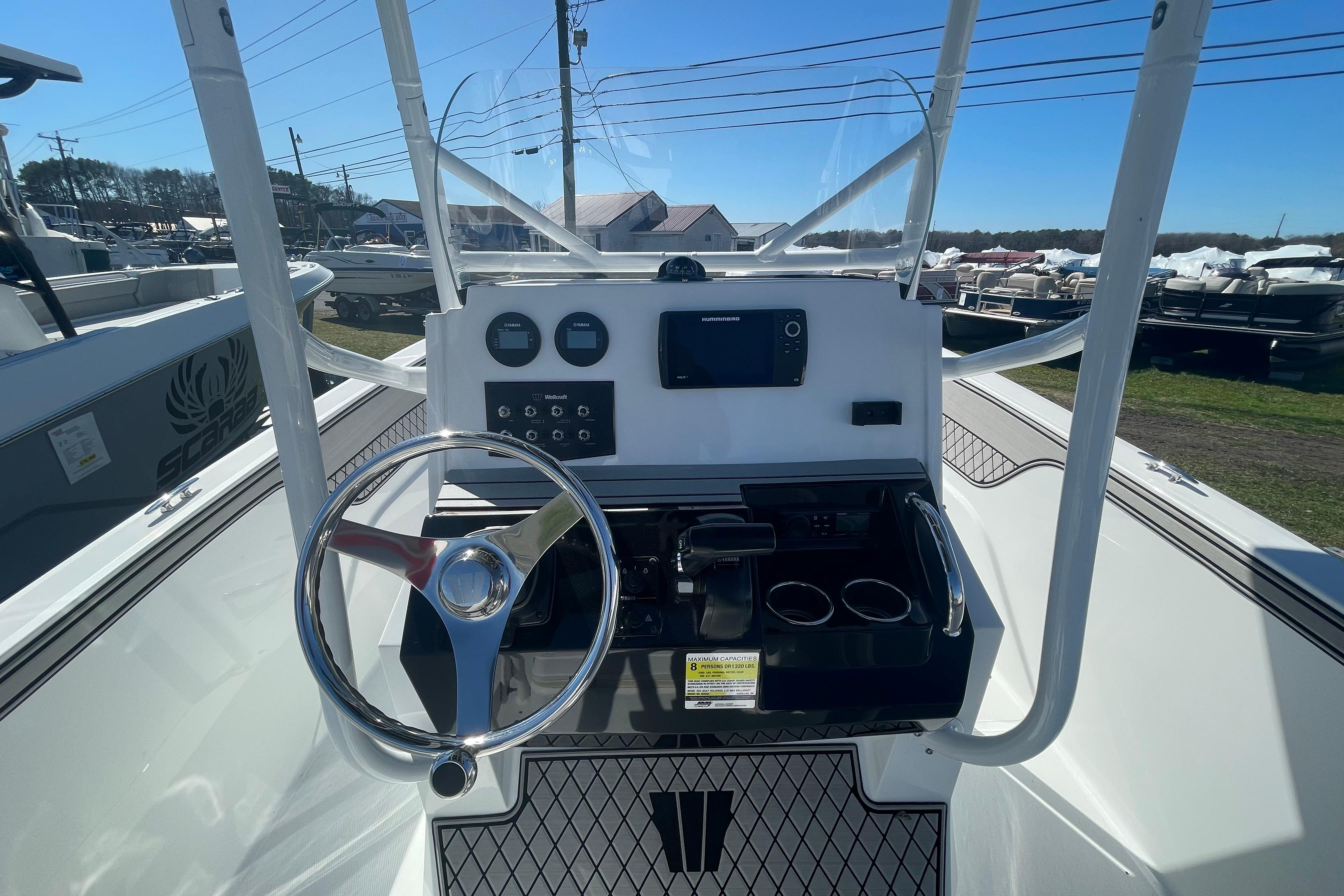 2022 Wellcraft 202 Fisherman boat dashboard with steering wheel and controls.