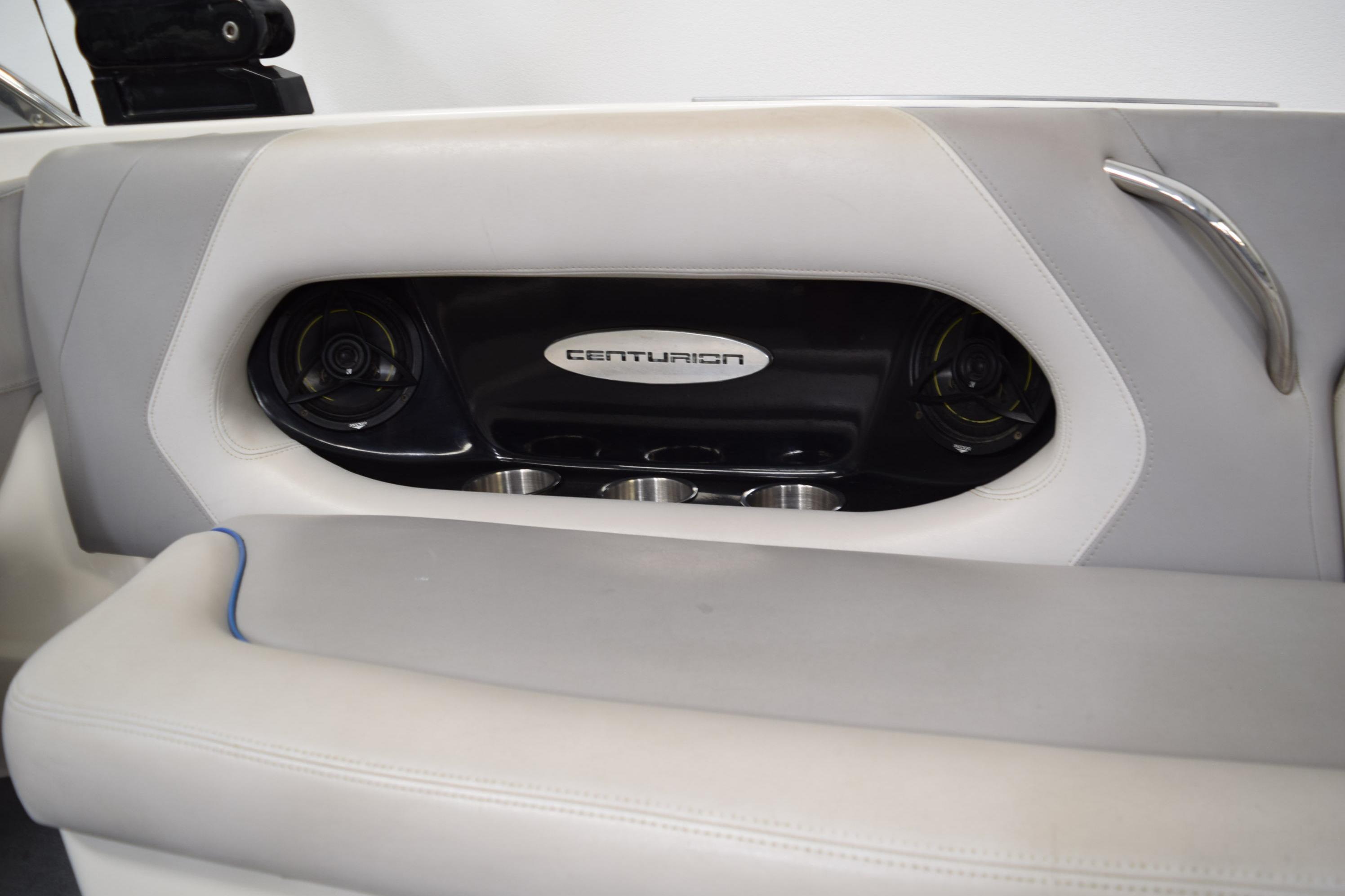 Interior of 2007 Centurion SV 240 boat with speaker and cup holders.
