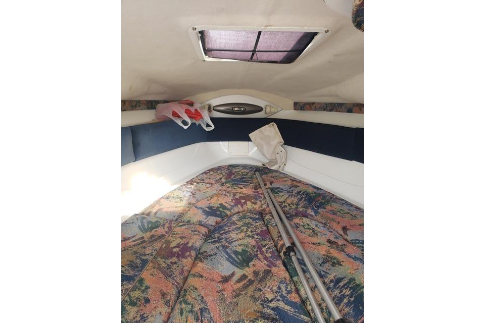 Interior cabin of 2001 Campion Allante 705 boat with colorful upholstery.
