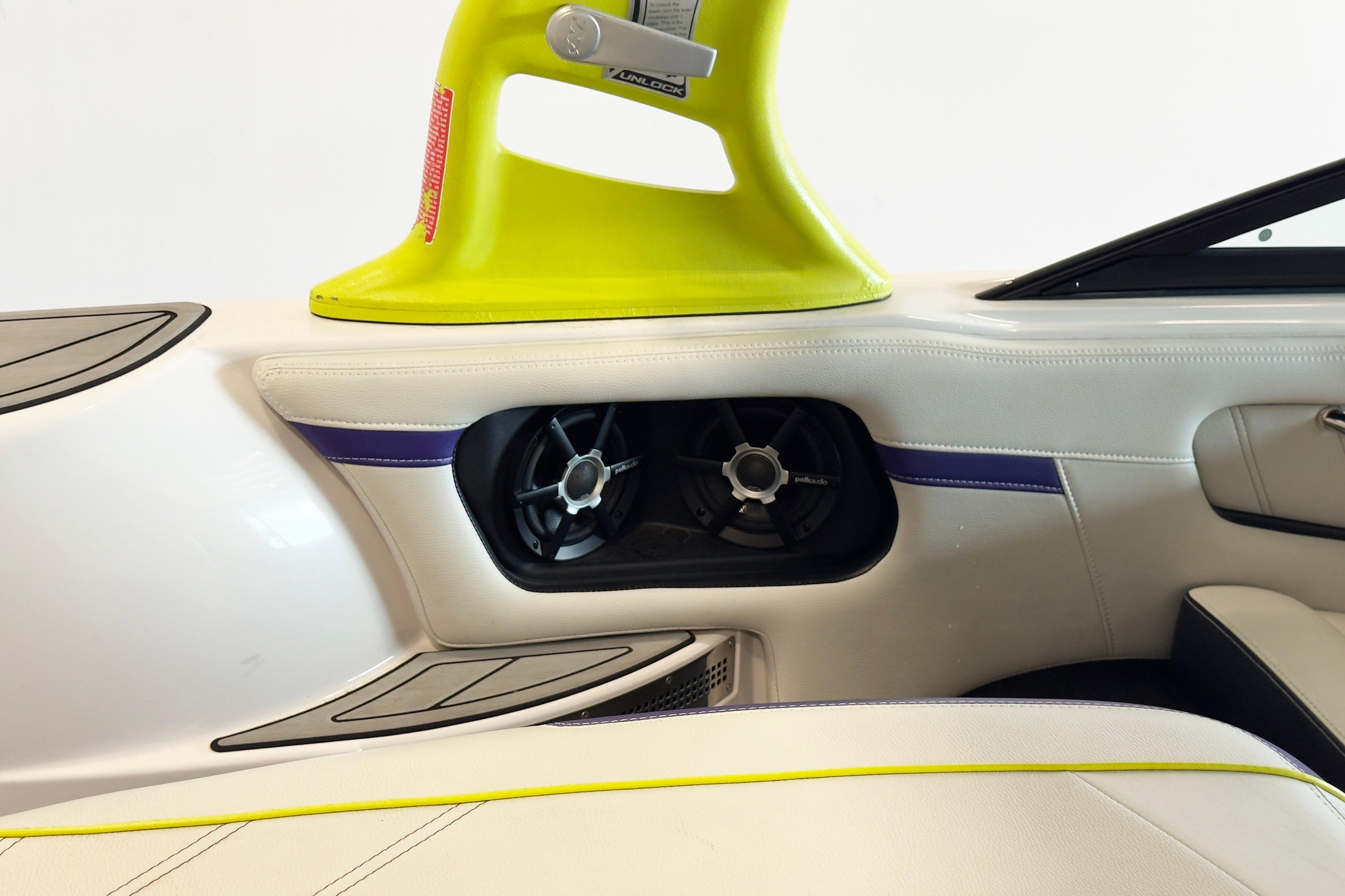 2014 Nautique Ski Nautique 200 interior with speaker and vibrant yellow accents.