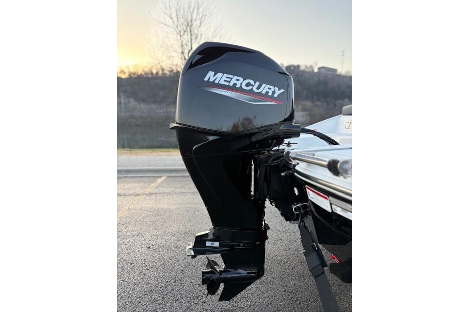 2026 Tahoe T16 boat with Mercury outboard motor, parked on asphalt.