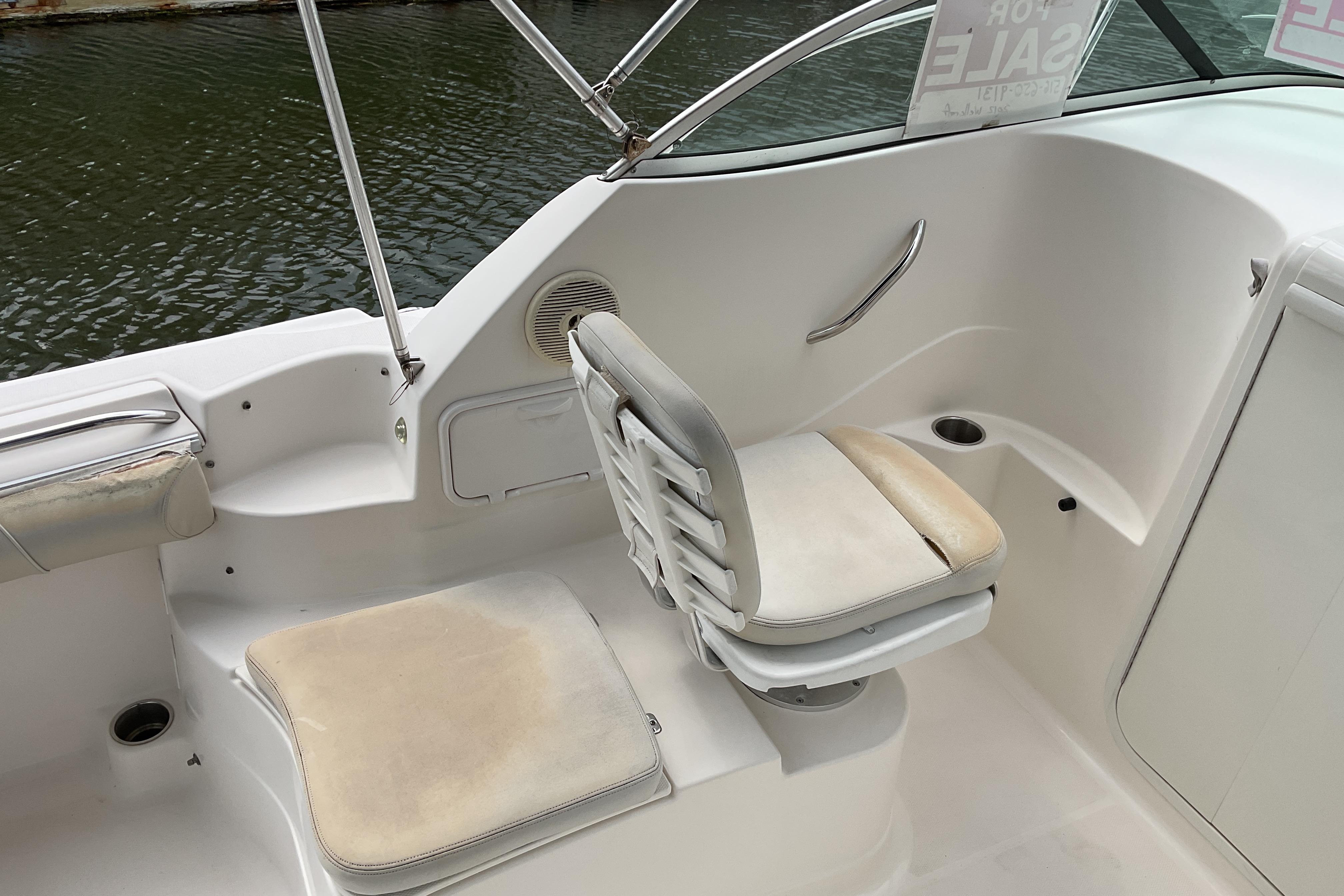 Interior of 2012 Wellcraft 232 Coastal boat with seating and cup holders.
