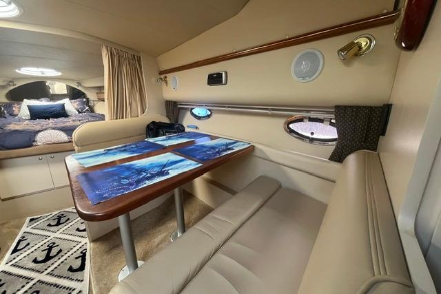 Interior of 2004 Cruisers Yachts 3372 Express with dining area and cozy sleeping quarters.