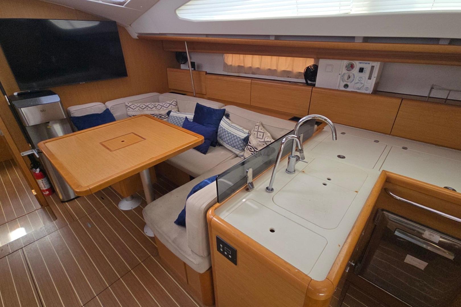 Interior of 2011 Jeanneau Sun Odyssey 50 DS yacht with modern kitchen and seating area.