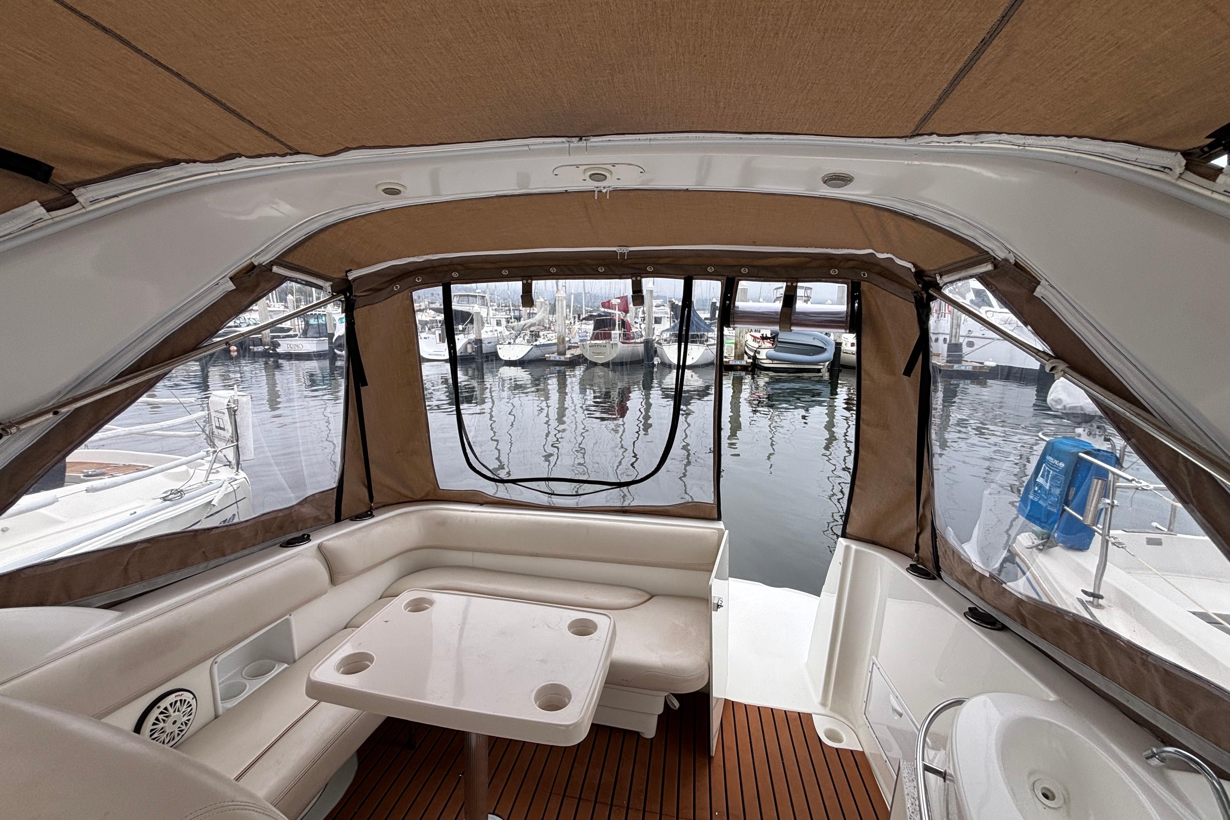 Interior view of a 2004 Larson 310 boat with marina backdrop.
