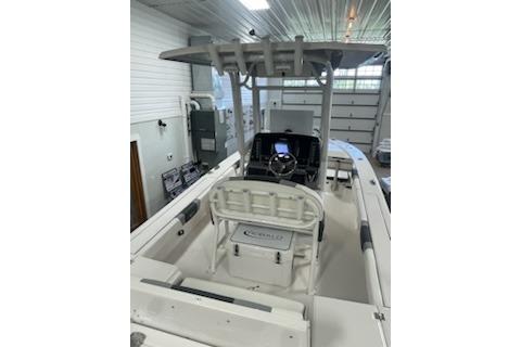 2024 Robalo 246 Cayman boat interior with console and seating in a garage setting.