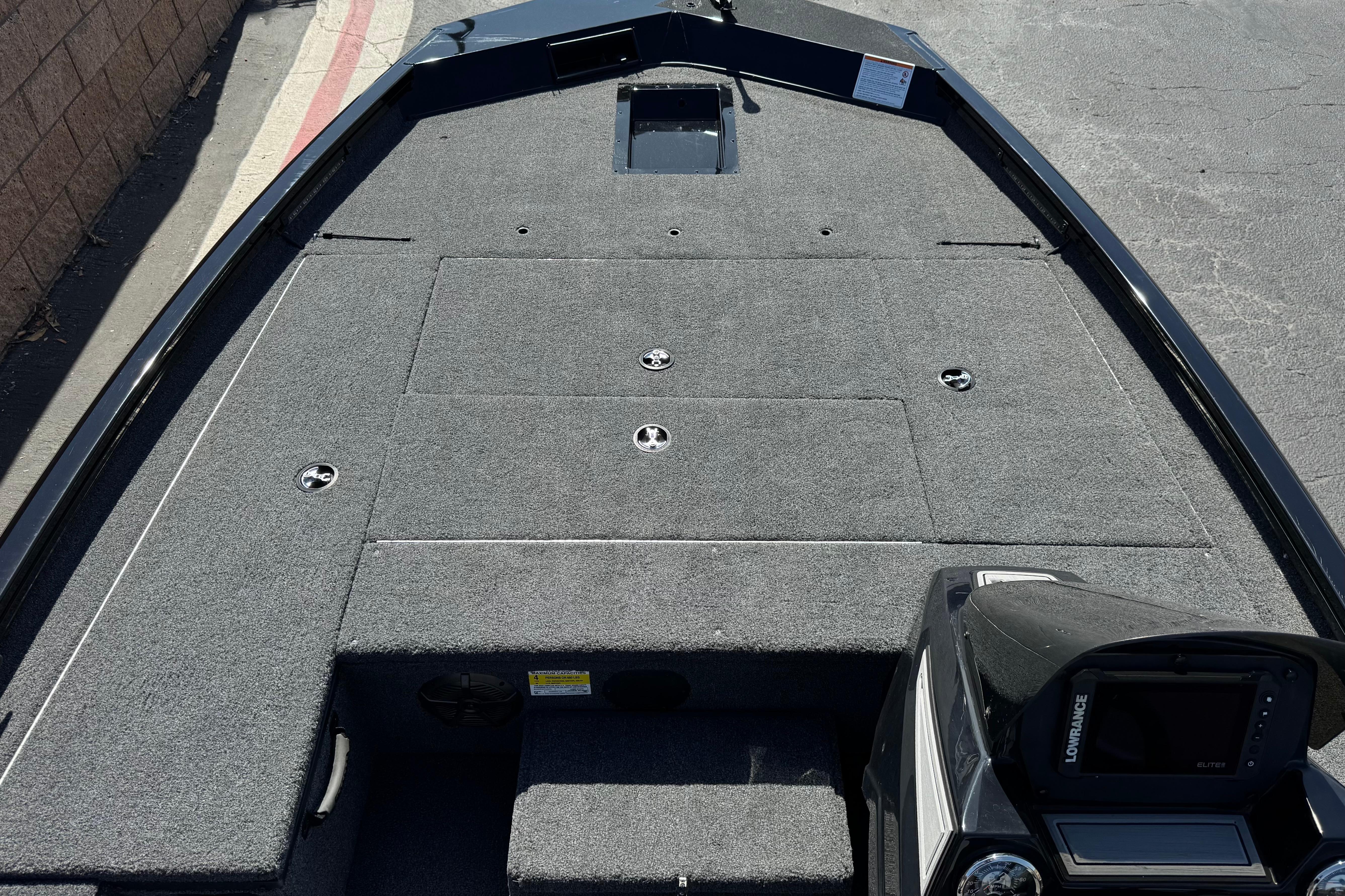 2024 Lowe Stinger 175 boat interior with carpeted deck and control panel.