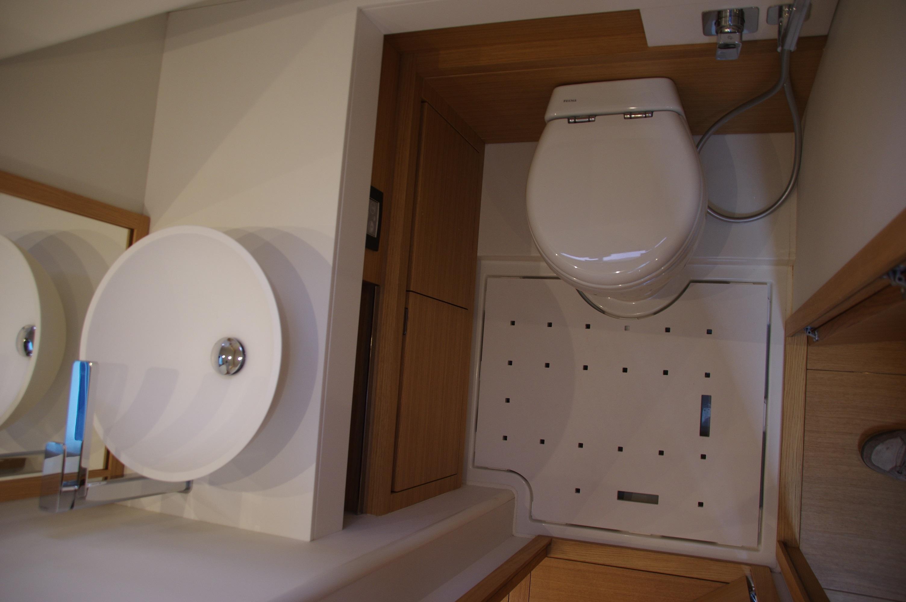 Modern bathroom in 2025 Pardo Yachts 50, featuring sleek sink and toilet design.