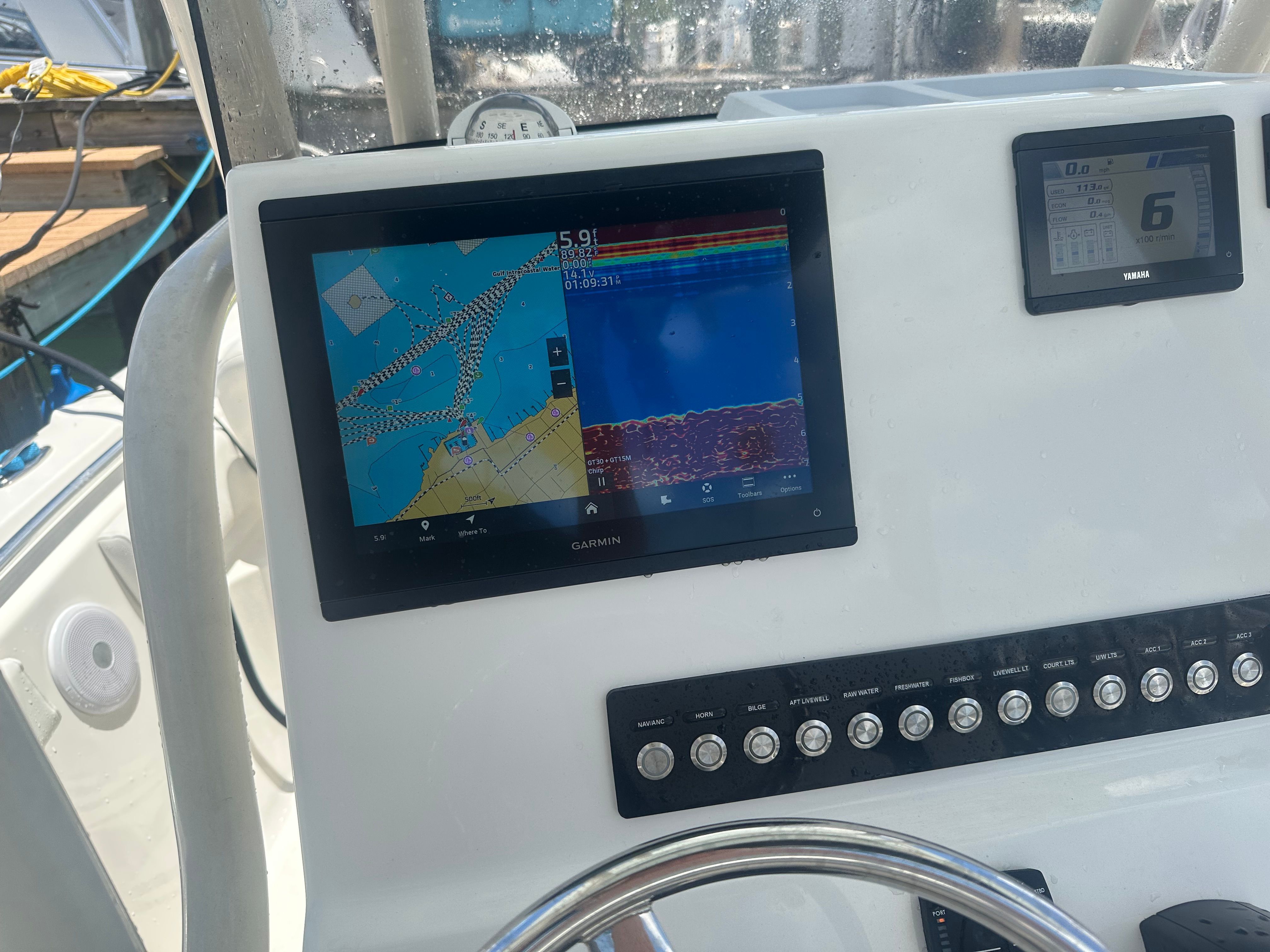 A modern boat with a navigation system and control console in the cockpit.