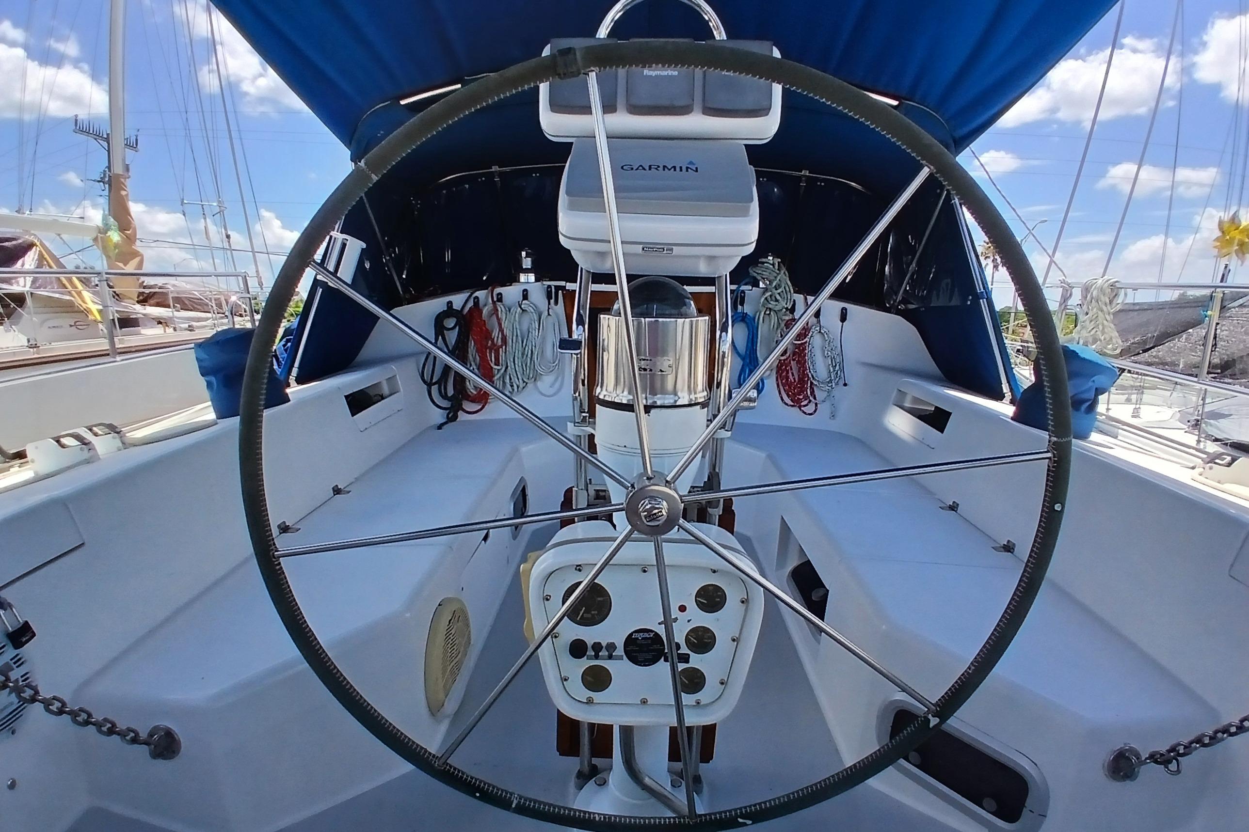 Cockpit of a 1995 Catalina 42 MkII sailboat with steering wheel and navigation equipment.