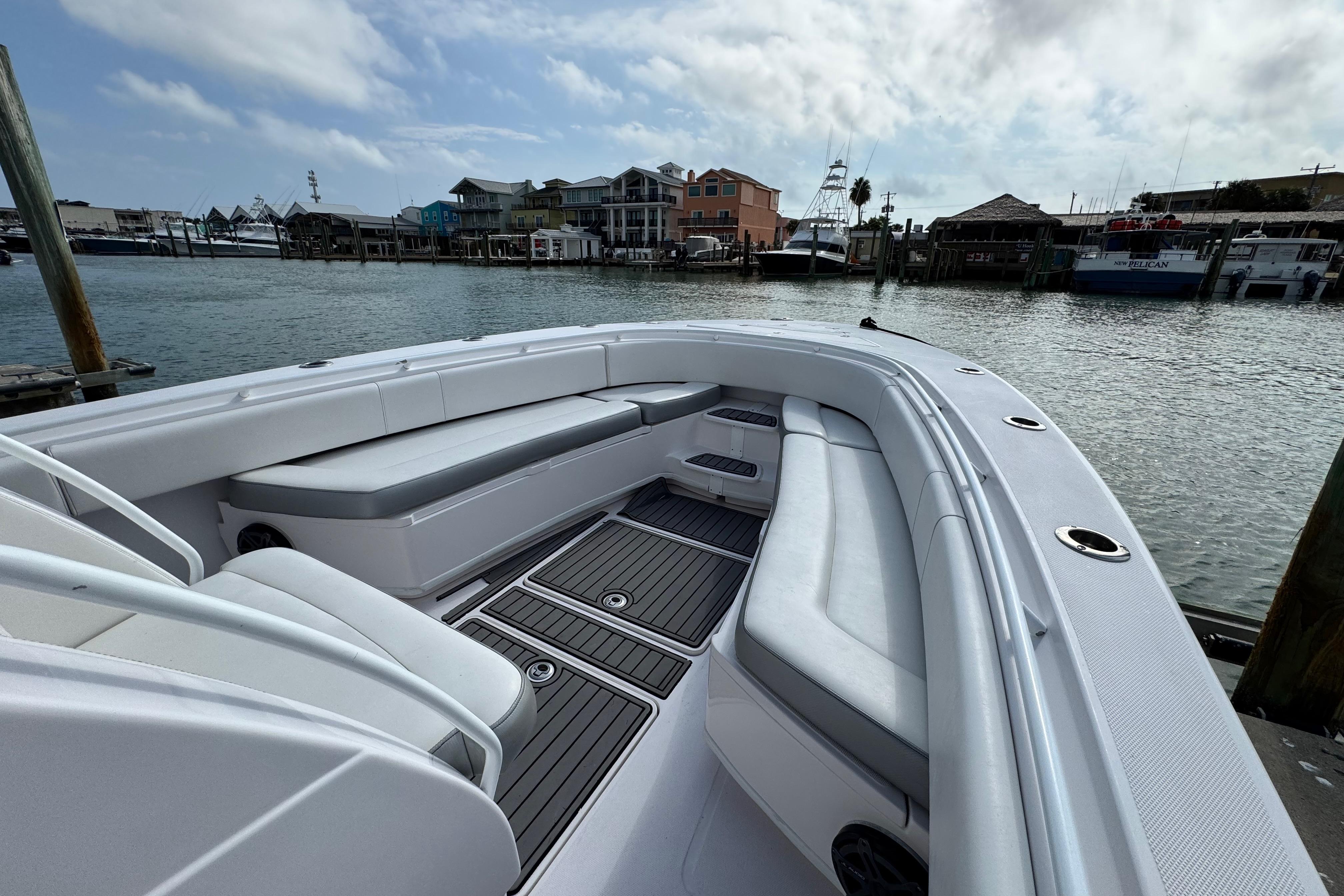 2018 Fountain 34 Center Console boat with spacious seating, docked at a marina.