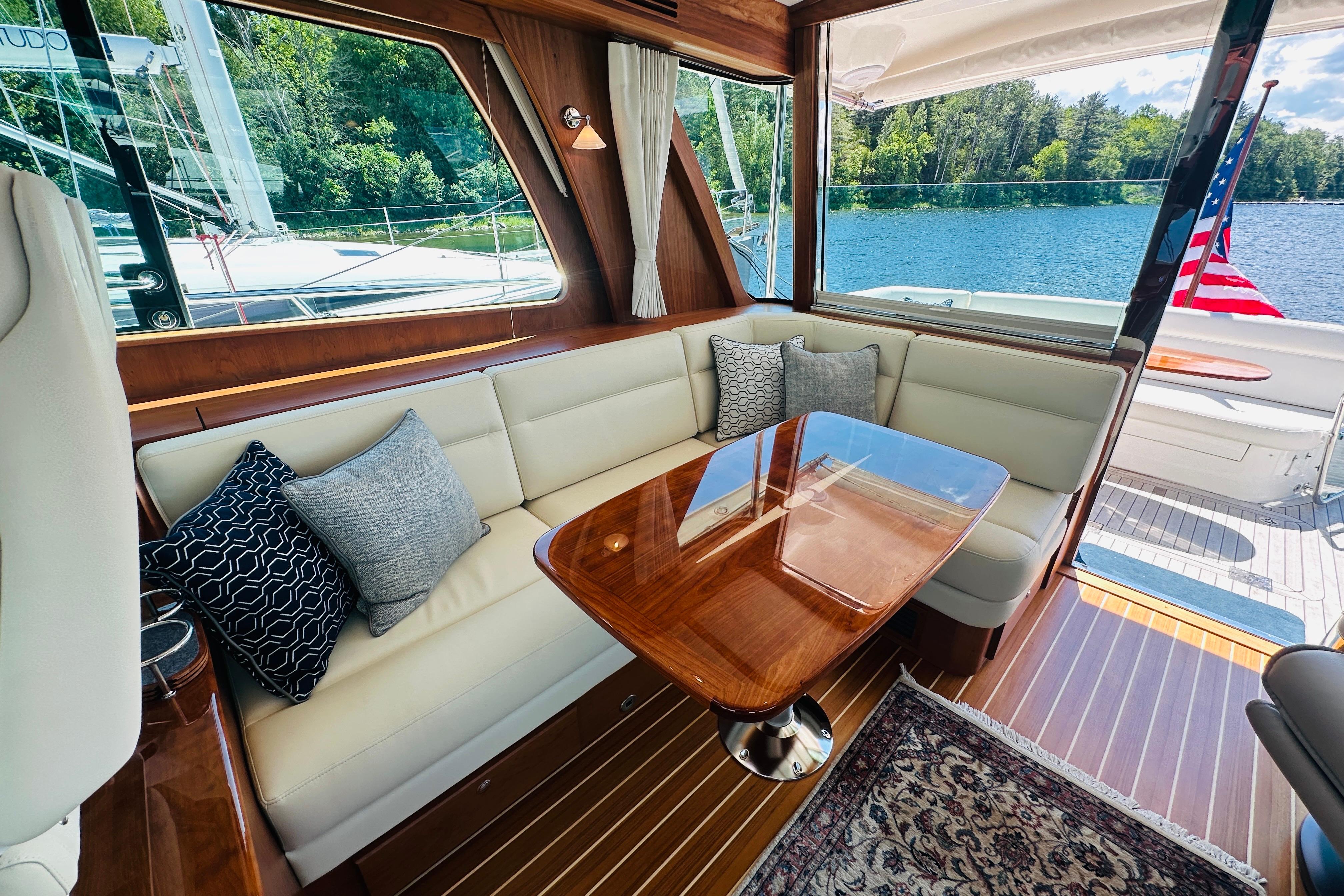 Luxurious interior of 2025 Sabre 48 Salon Express yacht with elegant seating and scenic water view.