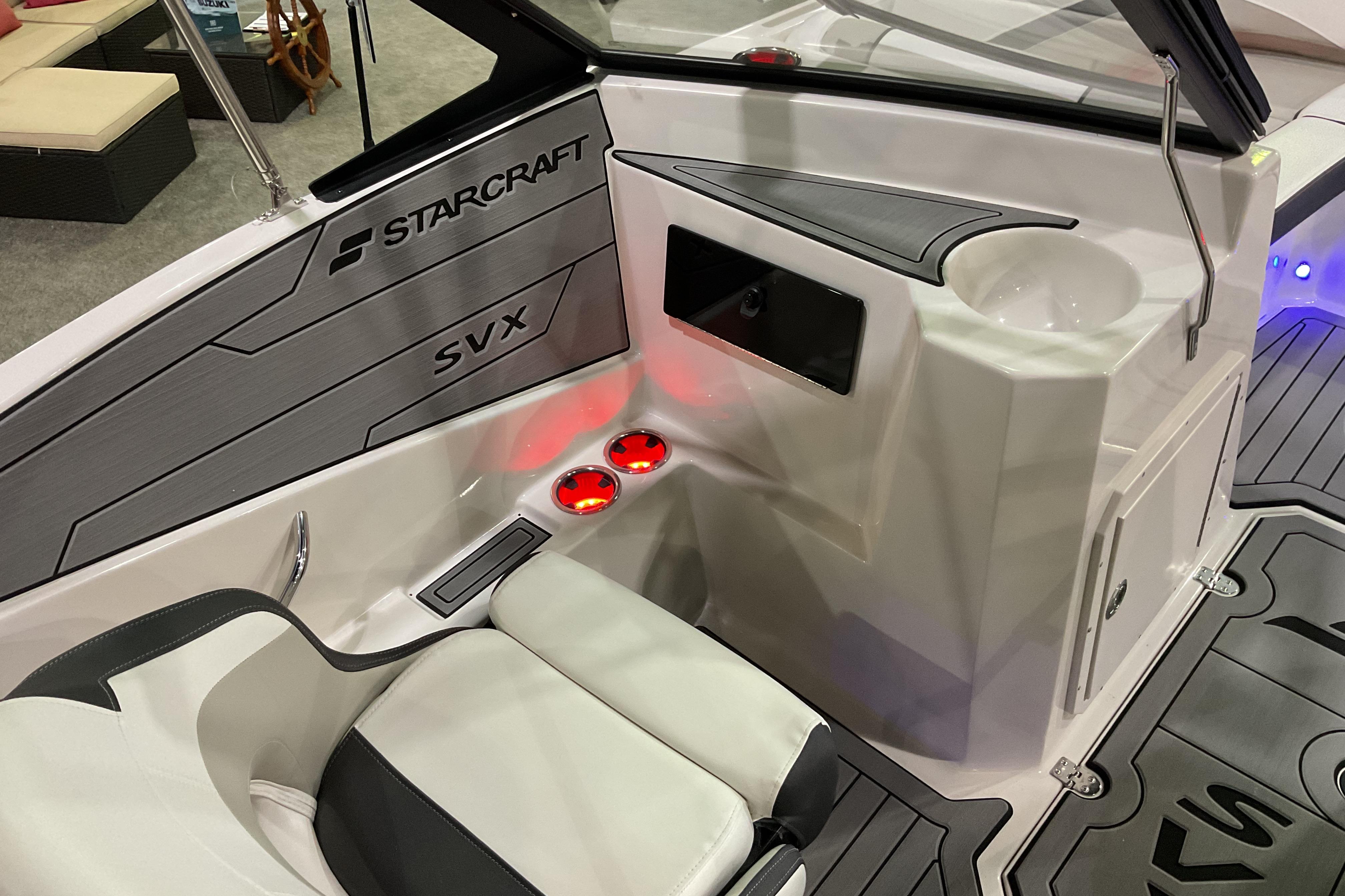 Interior of 2026 Starcraft SVX 210 DC OB boat with seating and cup holders.
