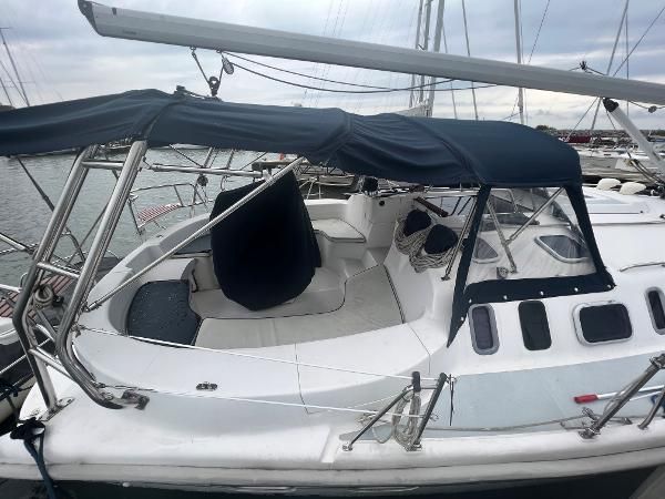 2000 Hunter 410 sailboat with blue canvas cover, docked at a marina.