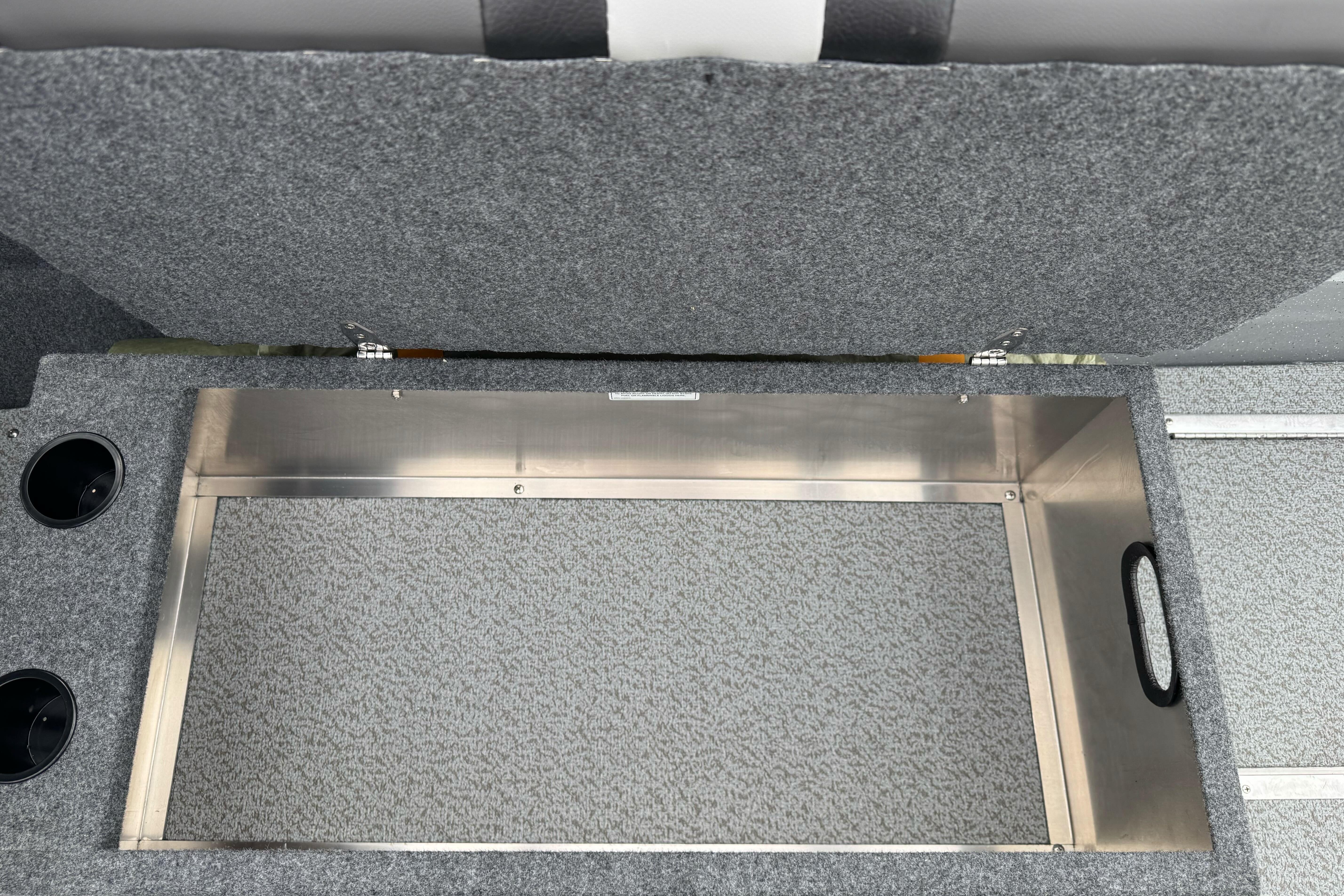 Open storage compartment in 2026 Lund 185 Heavy Gauge boat interior.