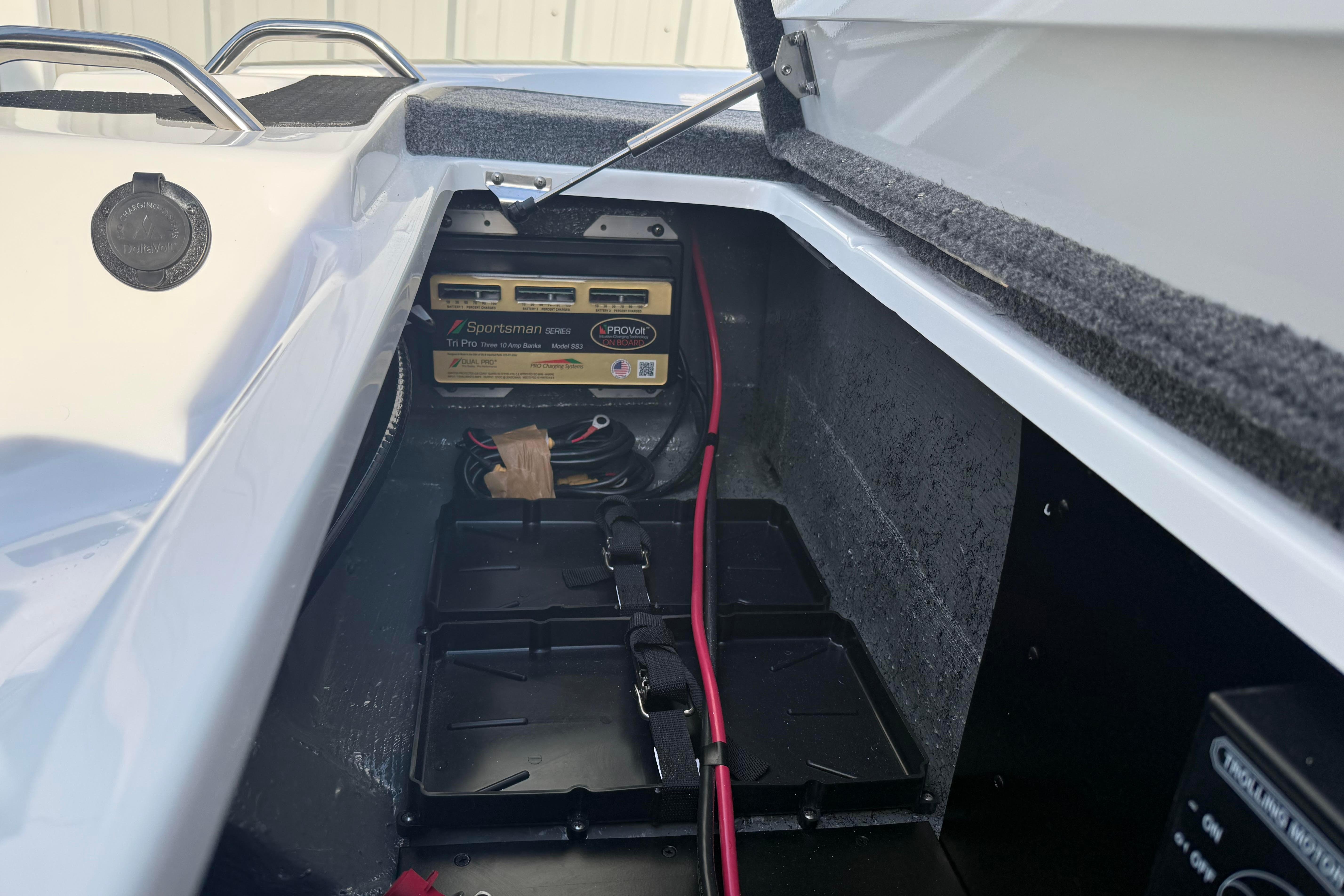 Battery compartment of 2027 Phoenix 721 ZXL boat with wiring and storage.