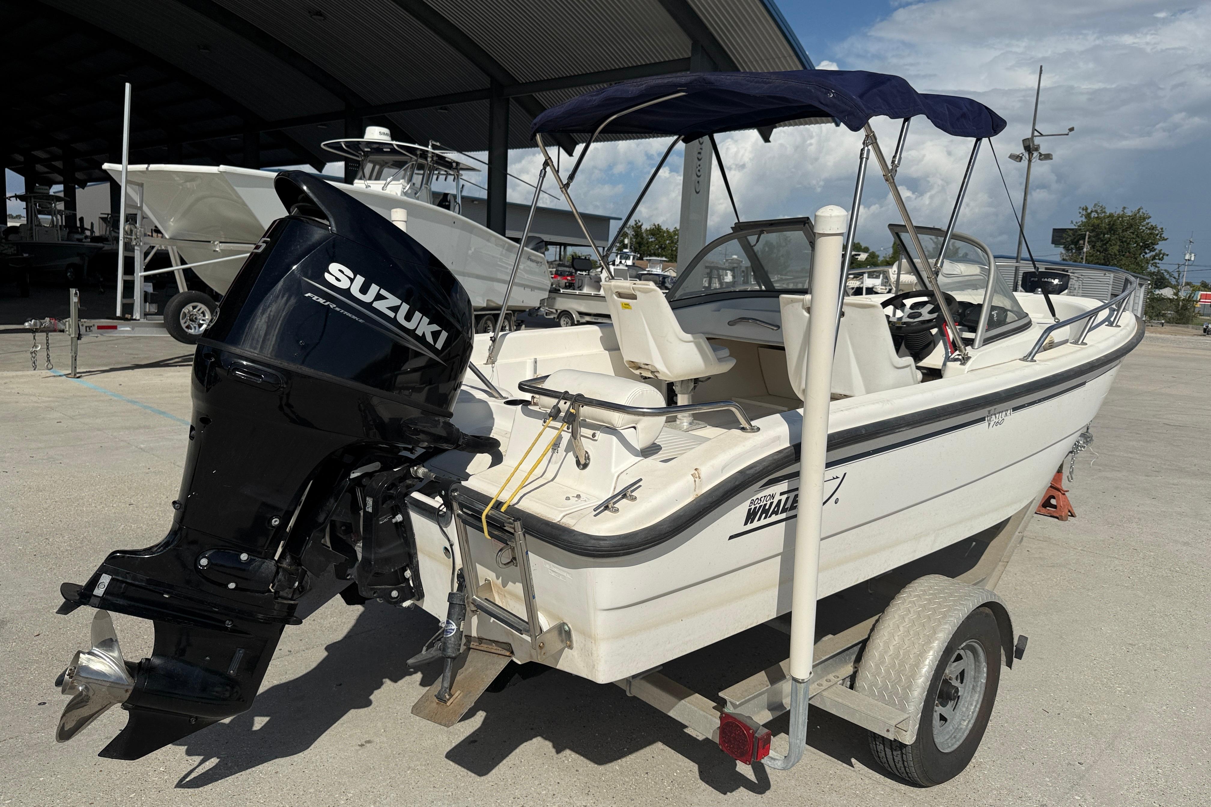 2002 Boston Whaler Ventura 160 boat with Suzuki outboard motor on trailer.