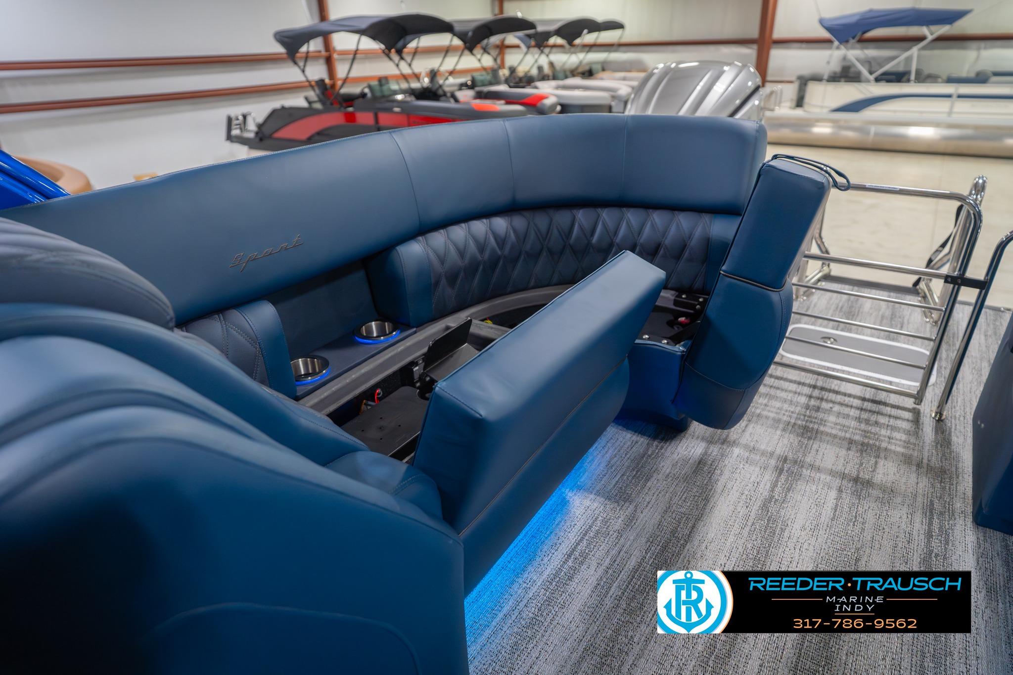2026 Bennington 27 RX boat interior with luxurious blue seating and cup holders.