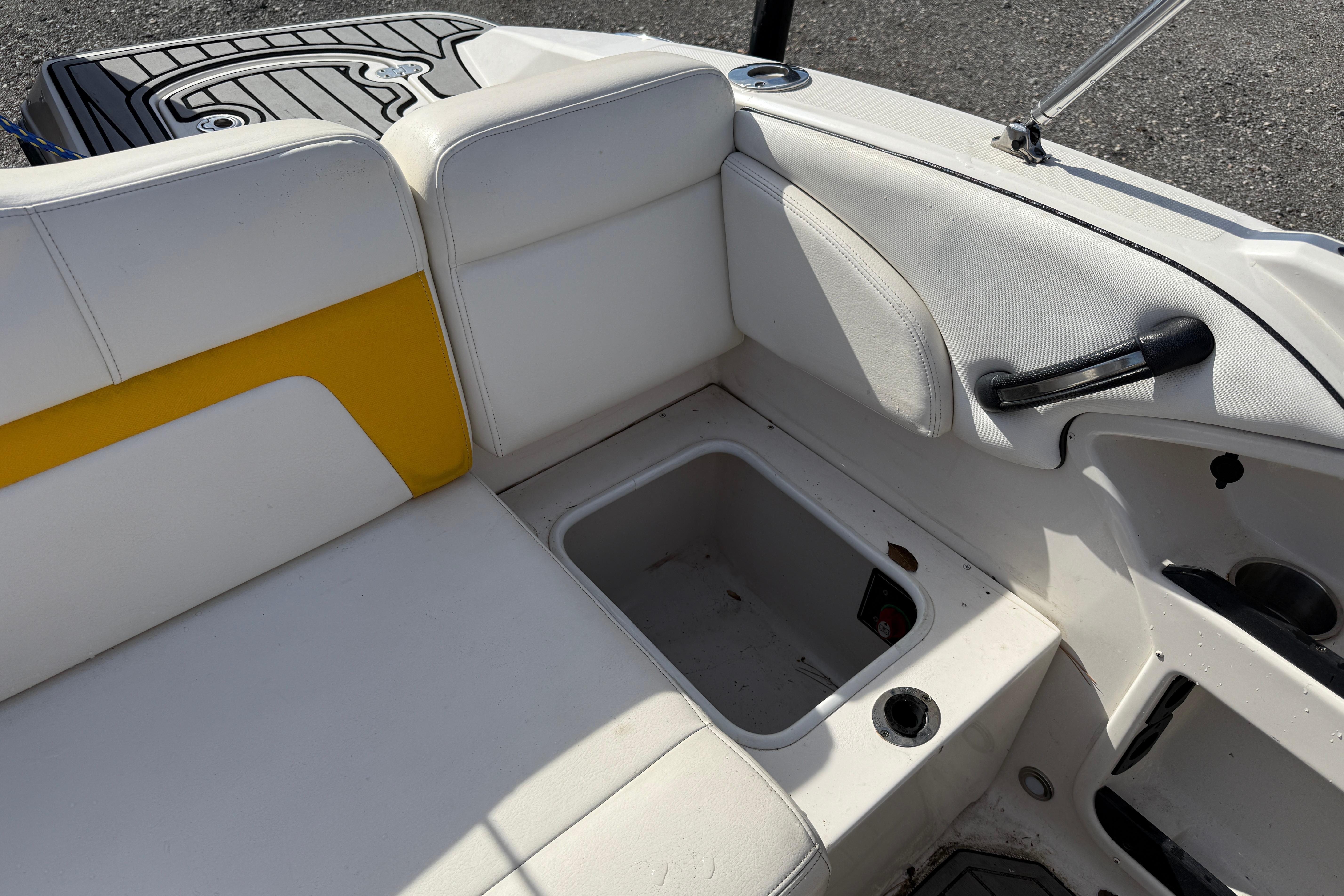 Interior of a 2014 Monterey 197 Blackfin boat with white and yellow seating.