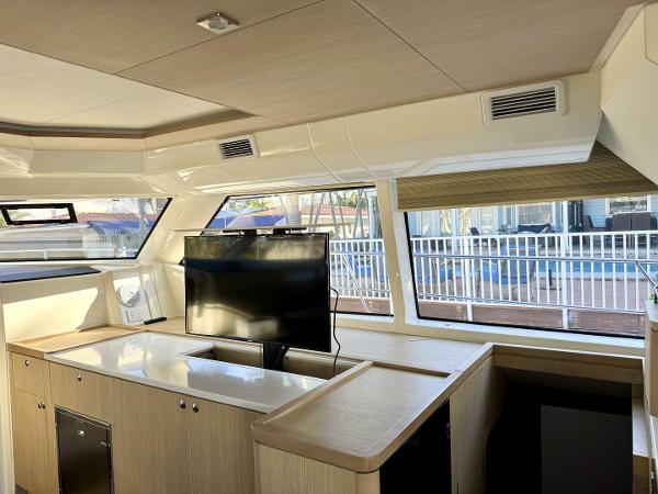 Interior of 2022 Aquila 44 yacht with modern design and large windows.