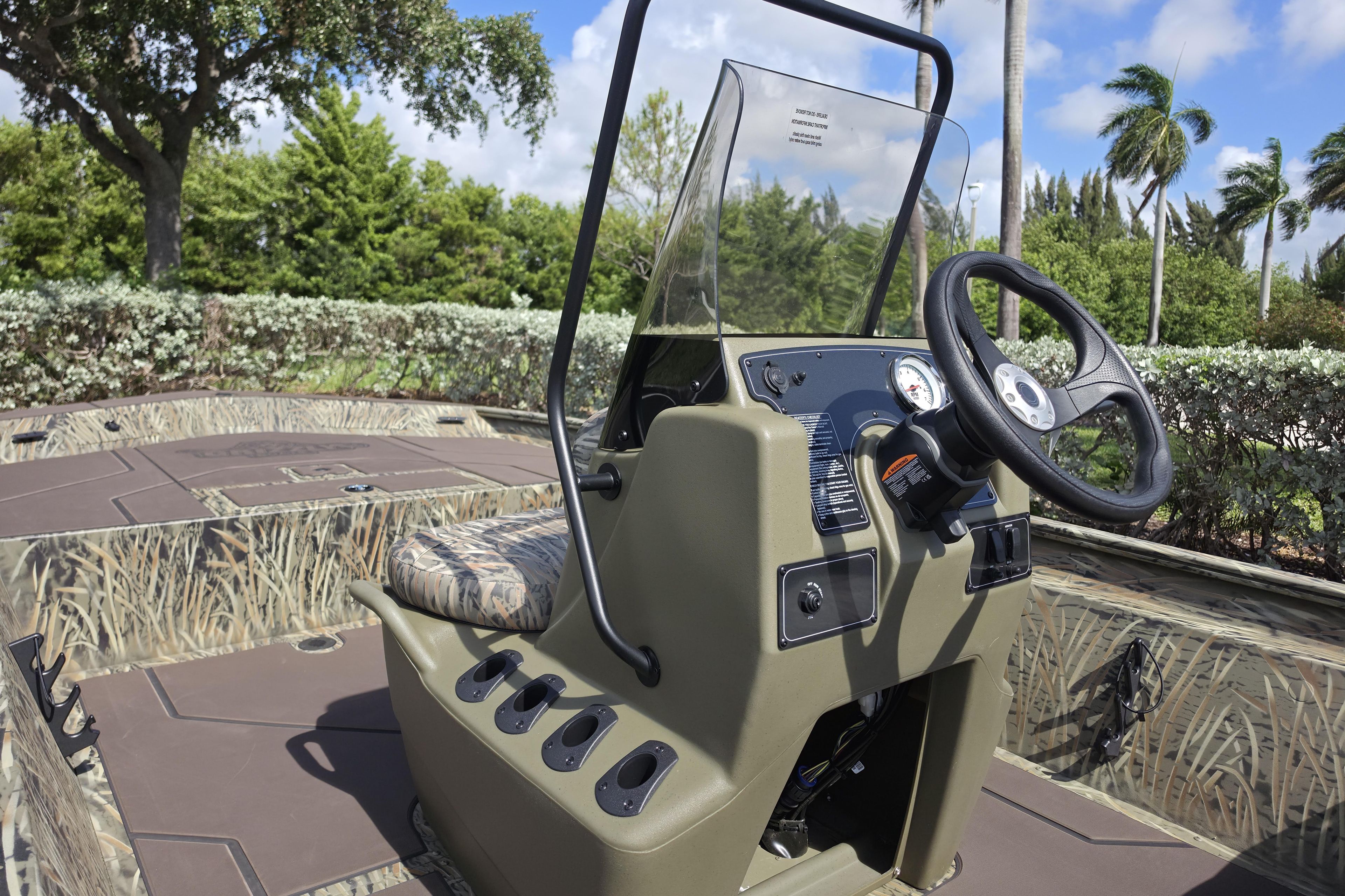 2026 Tracker Grizzly 1860 CC boat with camouflage design and steering console.