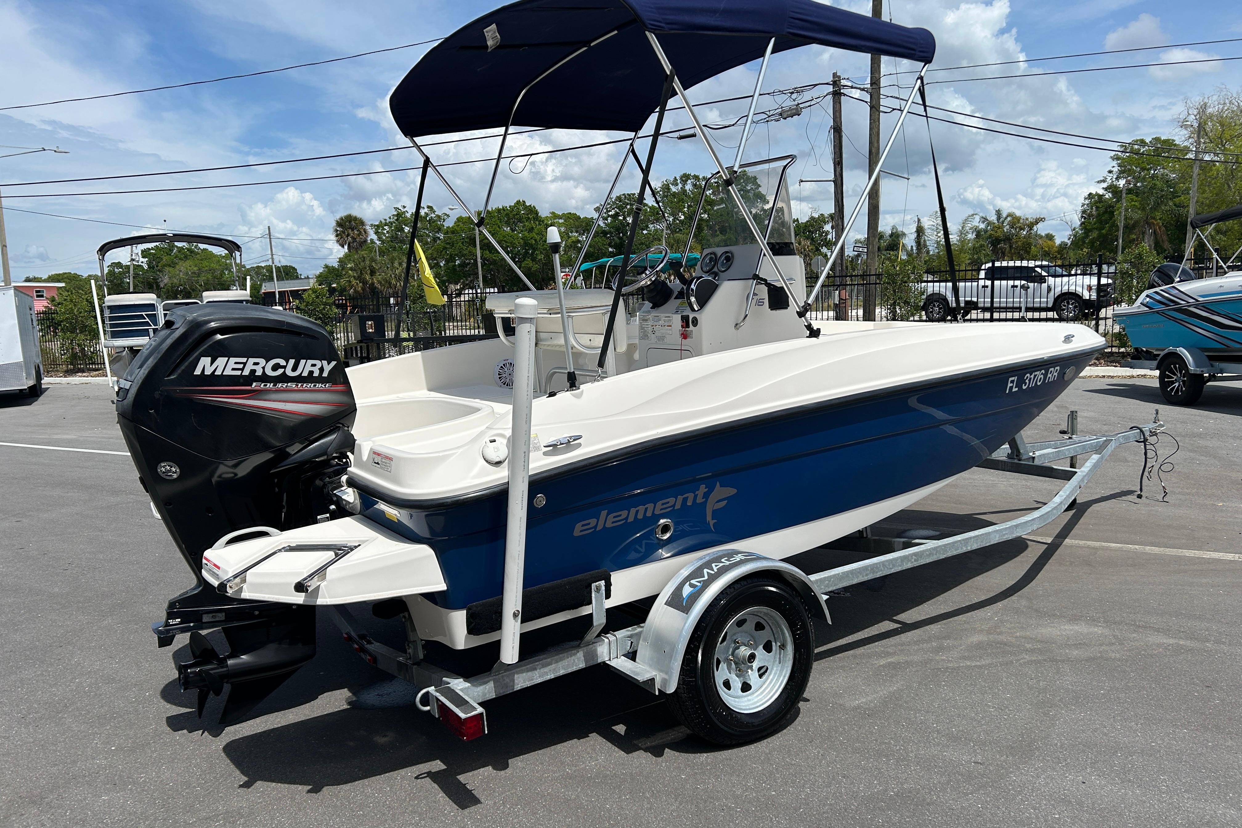 2018 Bayliner Element F16 boat with Mercury engine on trailer, parked outdoors.