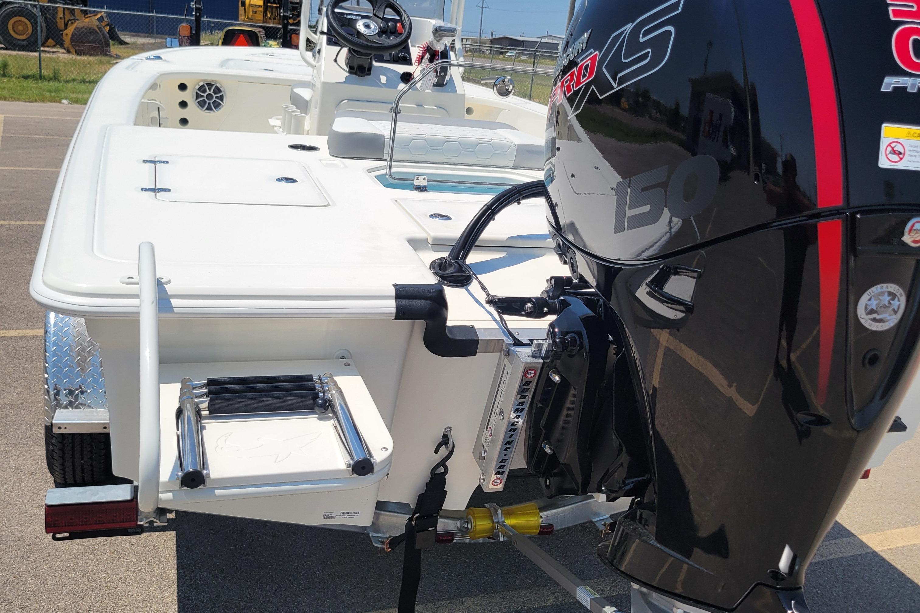 2026 Mako 18 Pro Skiff with powerful outboard motor and rear ladder.