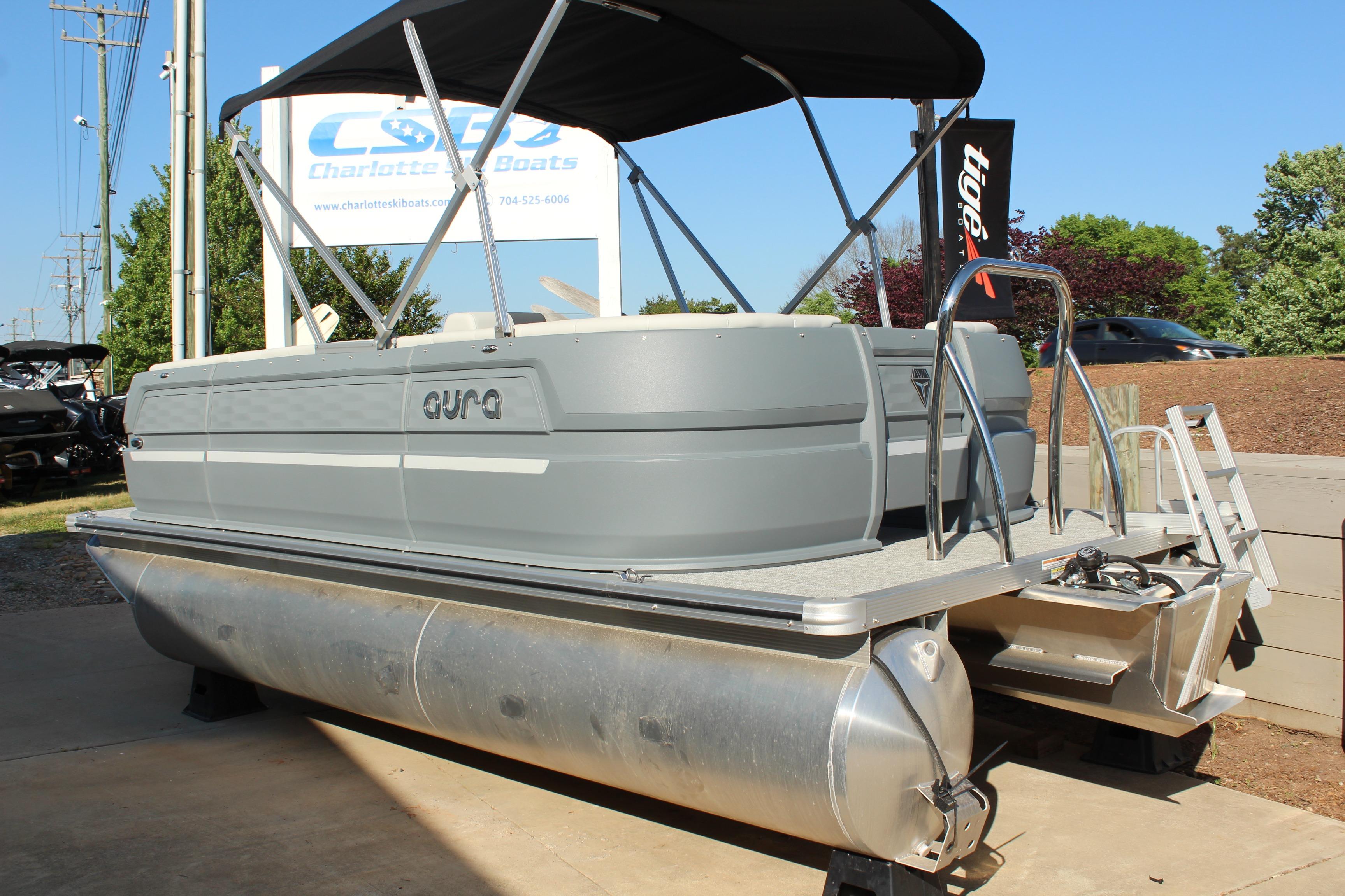 2026 Tahoe Pontoon Aura boat displayed outdoors at dealership.