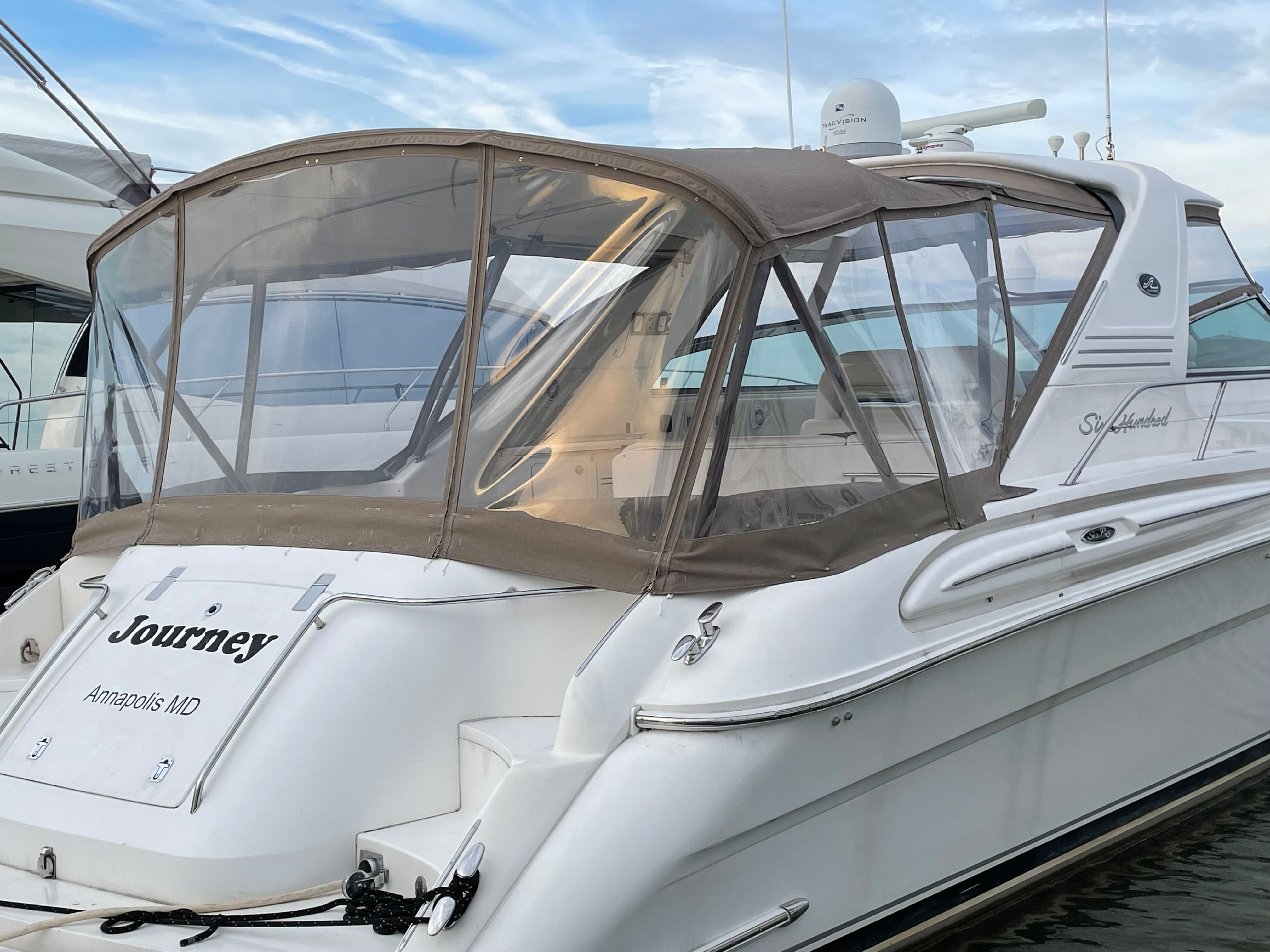 2003 Sea Ray S600 Sunsport with canopy docked at a marina.