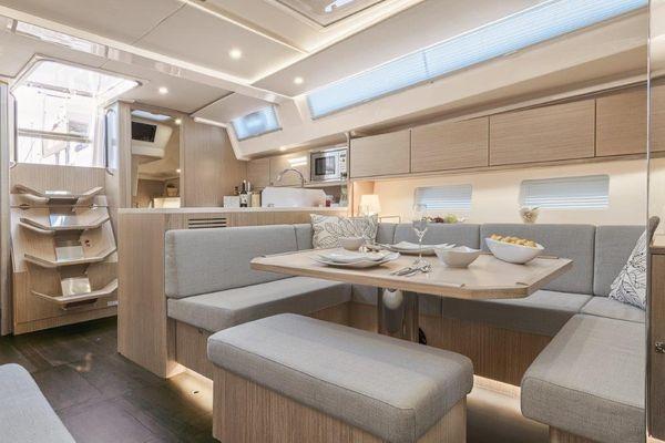 Luxurious interior of 2023 Bavaria C45 yacht with modern dining area and sleek design.