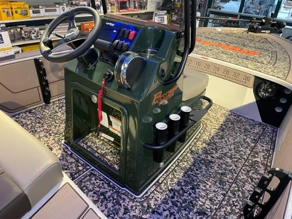 2025 Mako 18 Pro Skiff Backwater Edition boat interior with camo flooring and steering console.