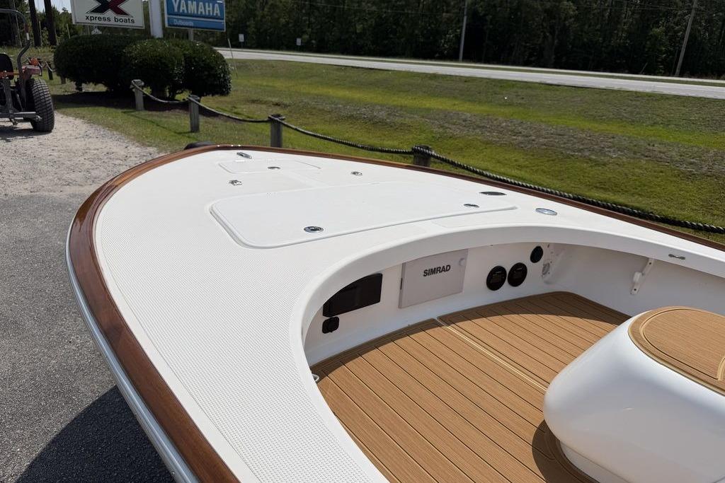 2012 Chaos 16 Bonefish boat with teak deck and Simrad electronics, parked near Yamaha sign.