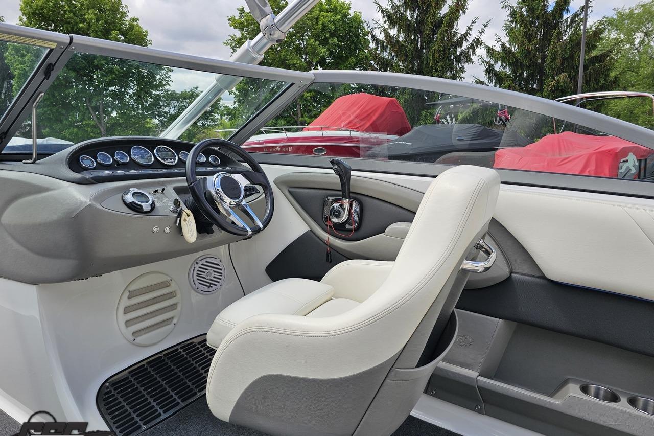 Interior of a 2010 Cobalt 232 WSS boat, featuring a sleek dashboard and comfortable seating.