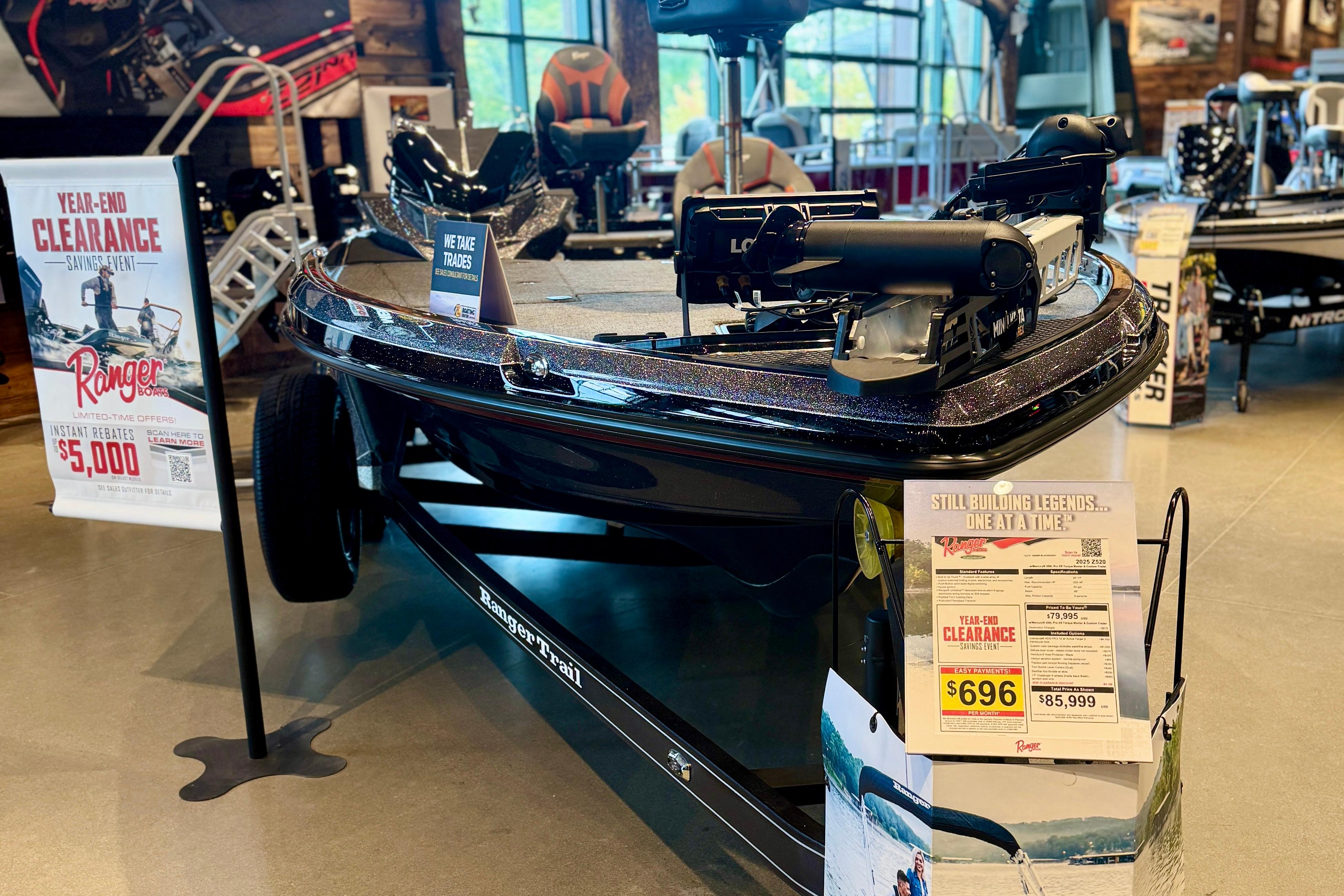 2025 Ranger Z520 boat on display with year-end clearance sale signs.