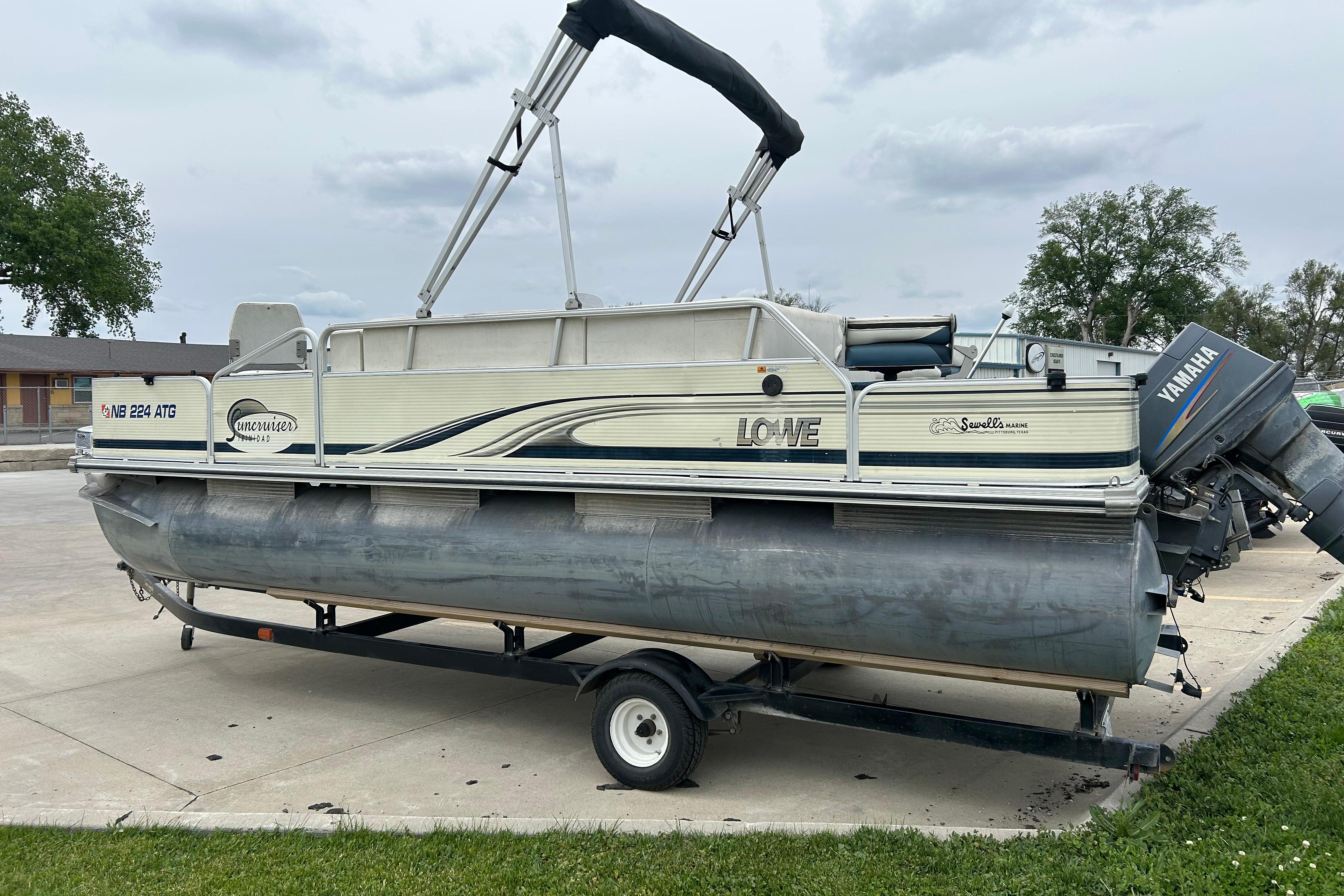 2002 Lowe Trinidad 200 pontoon boat on trailer with Yamaha outboard motor.